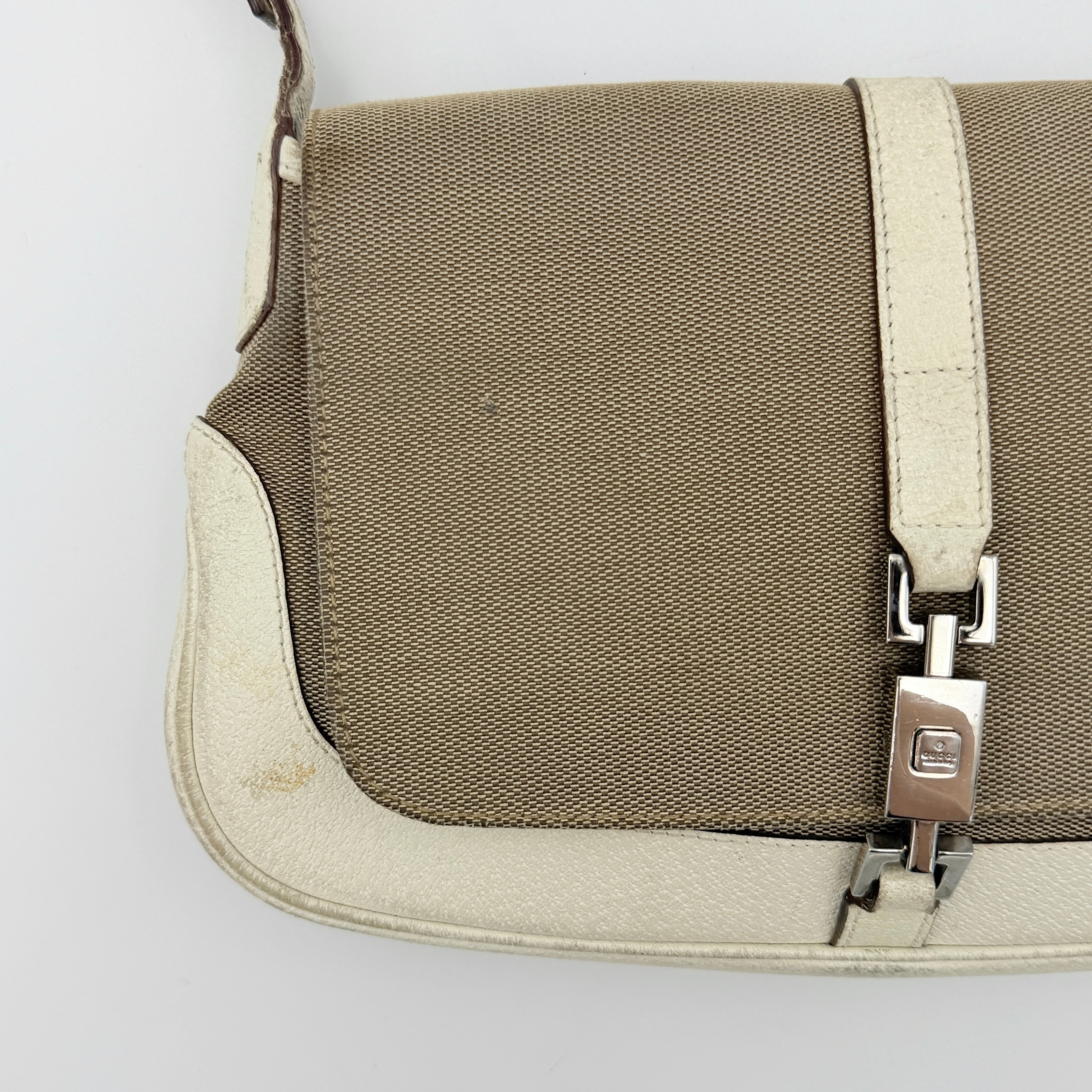 Gucci Jackie Shoulder Bag in brown canvas and white leather trim with silver-tone hardware, displayed against a clean background.