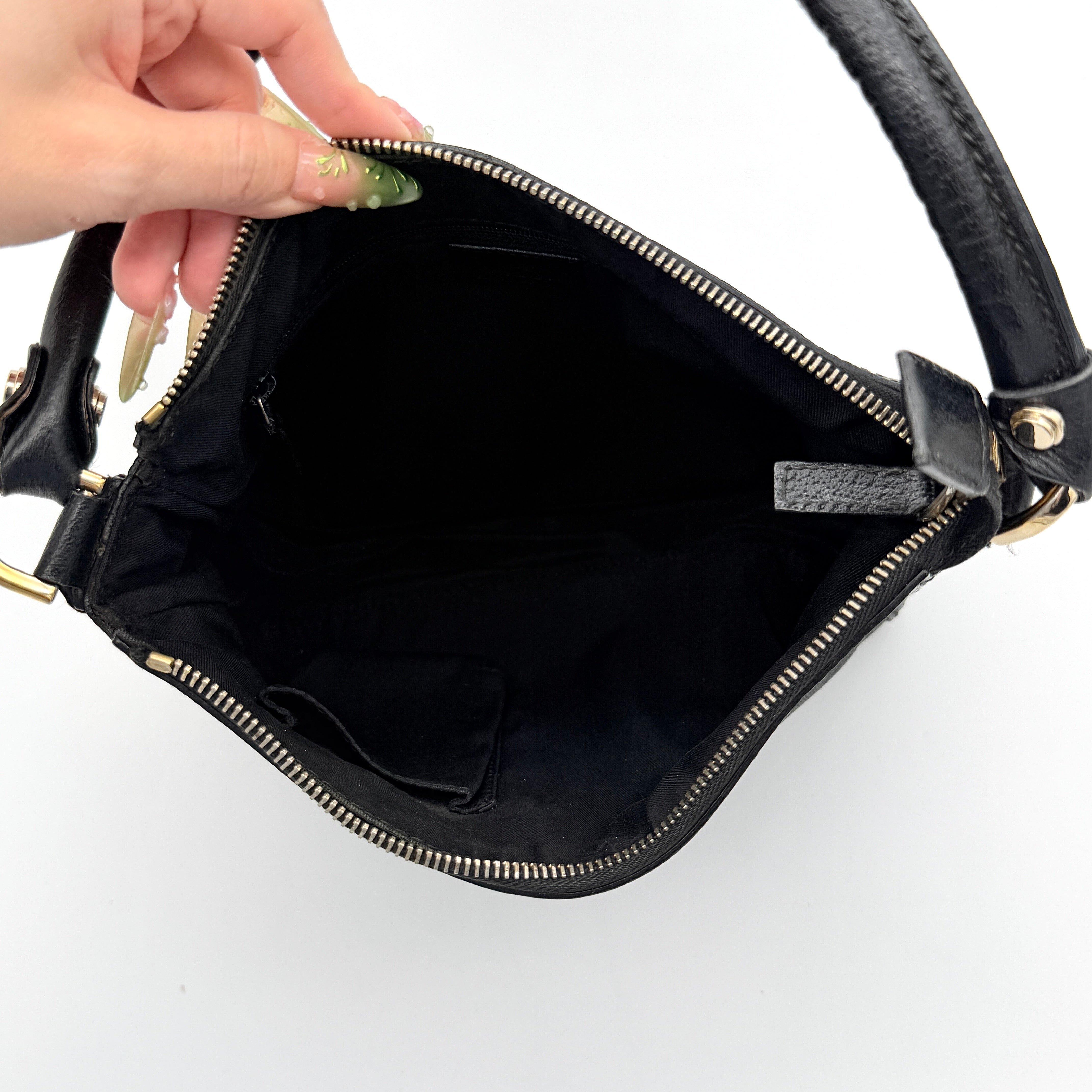 Front view of the Gucci GG Monogram Abbey Shoulder Bag in black with curved handle and gold hardware.