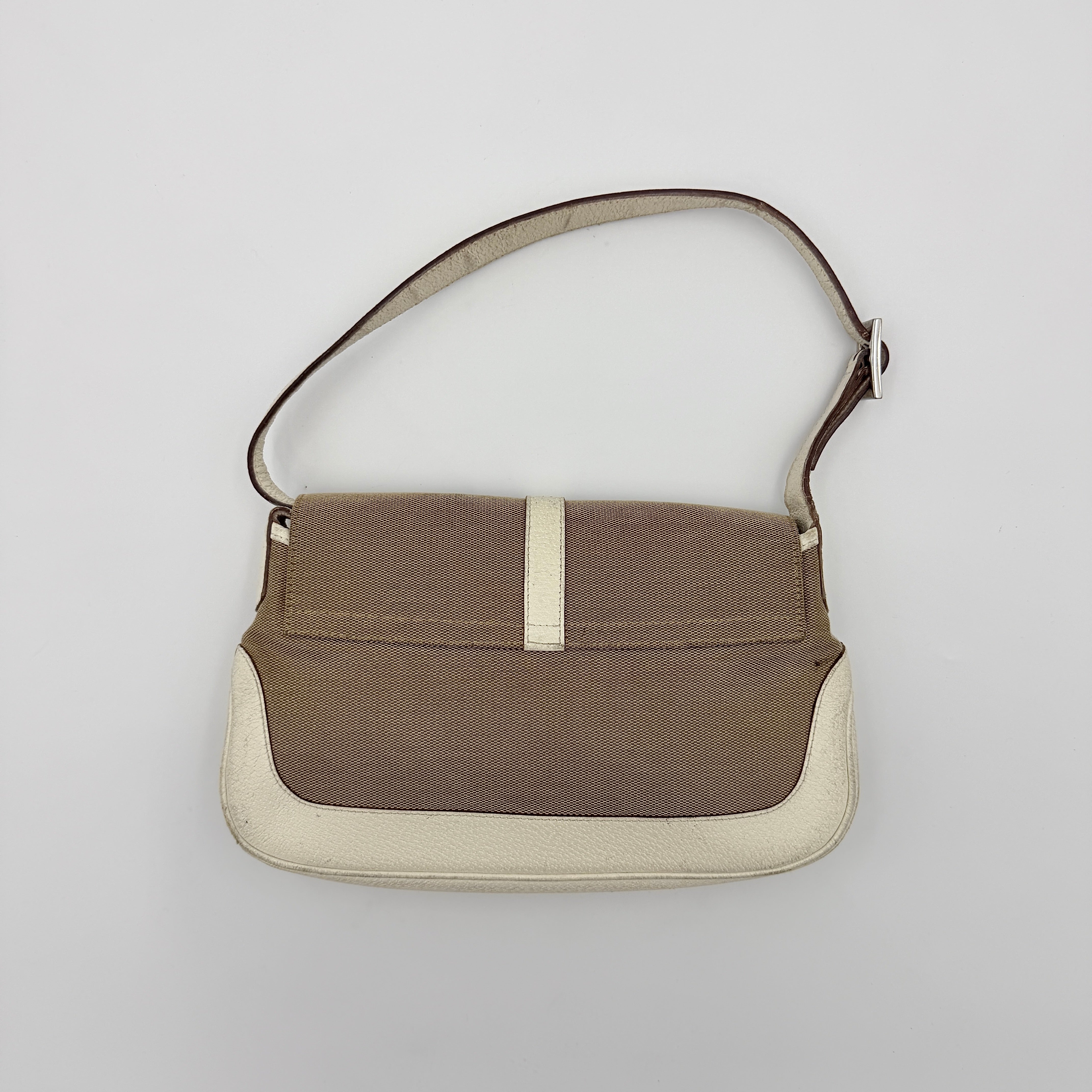Gucci Jackie Shoulder Bag in brown canvas and white leather trim with silver-tone hardware, displayed against a clean background.