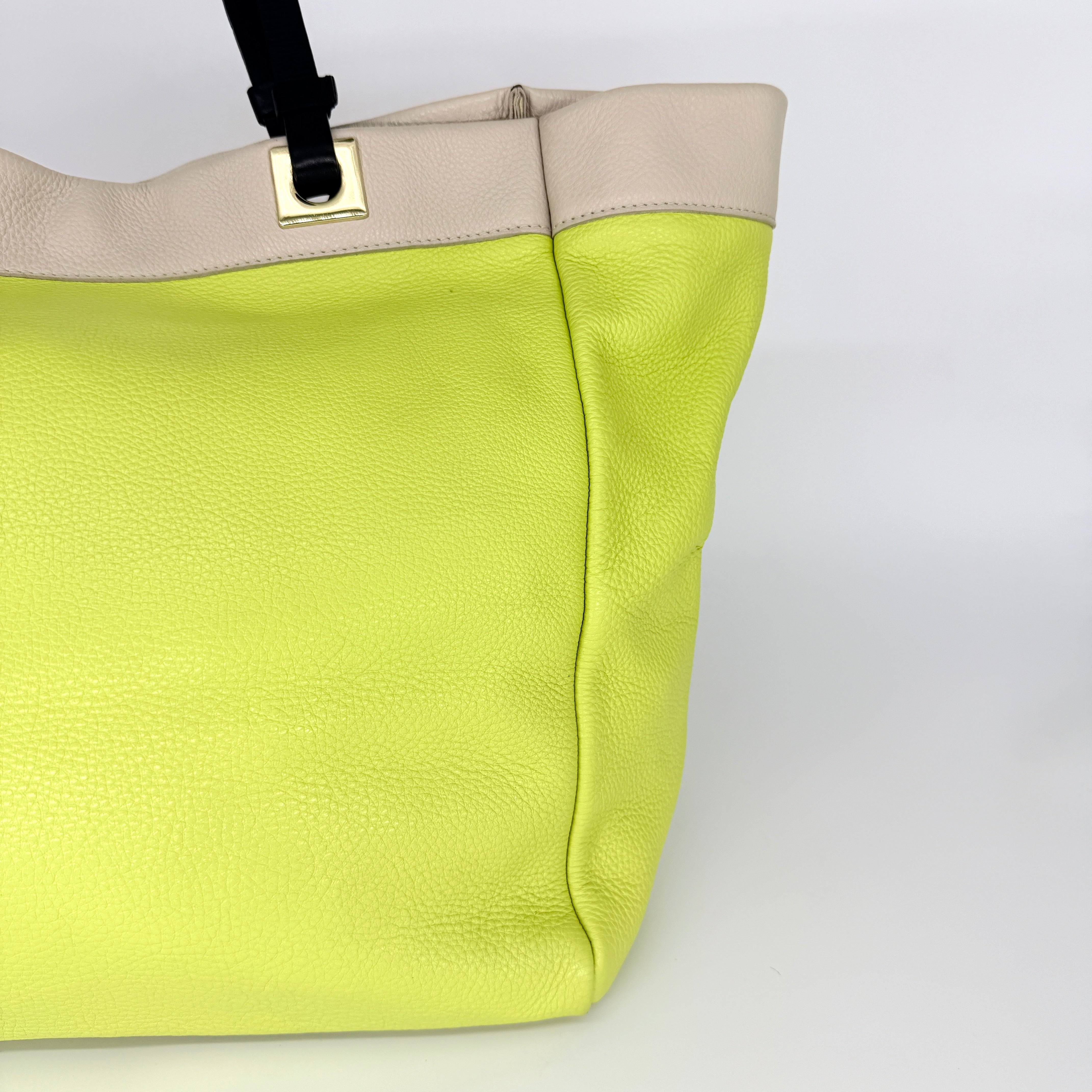 Furla Shopper Tote in neon yellow and beige grained leather with black handles and gold-tone hardware.