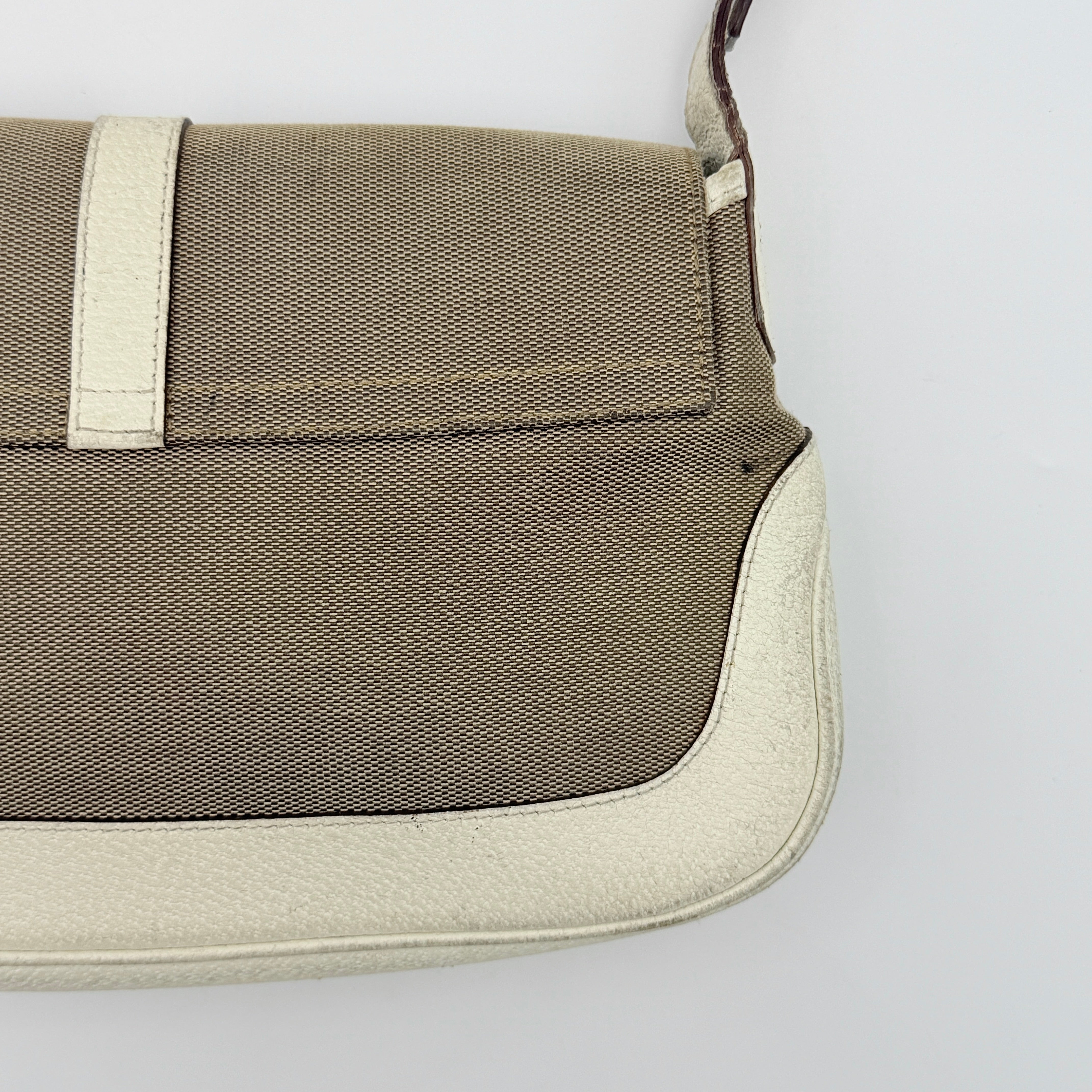Gucci Jackie Shoulder Bag in brown canvas and white leather trim with silver-tone hardware, displayed against a clean background.