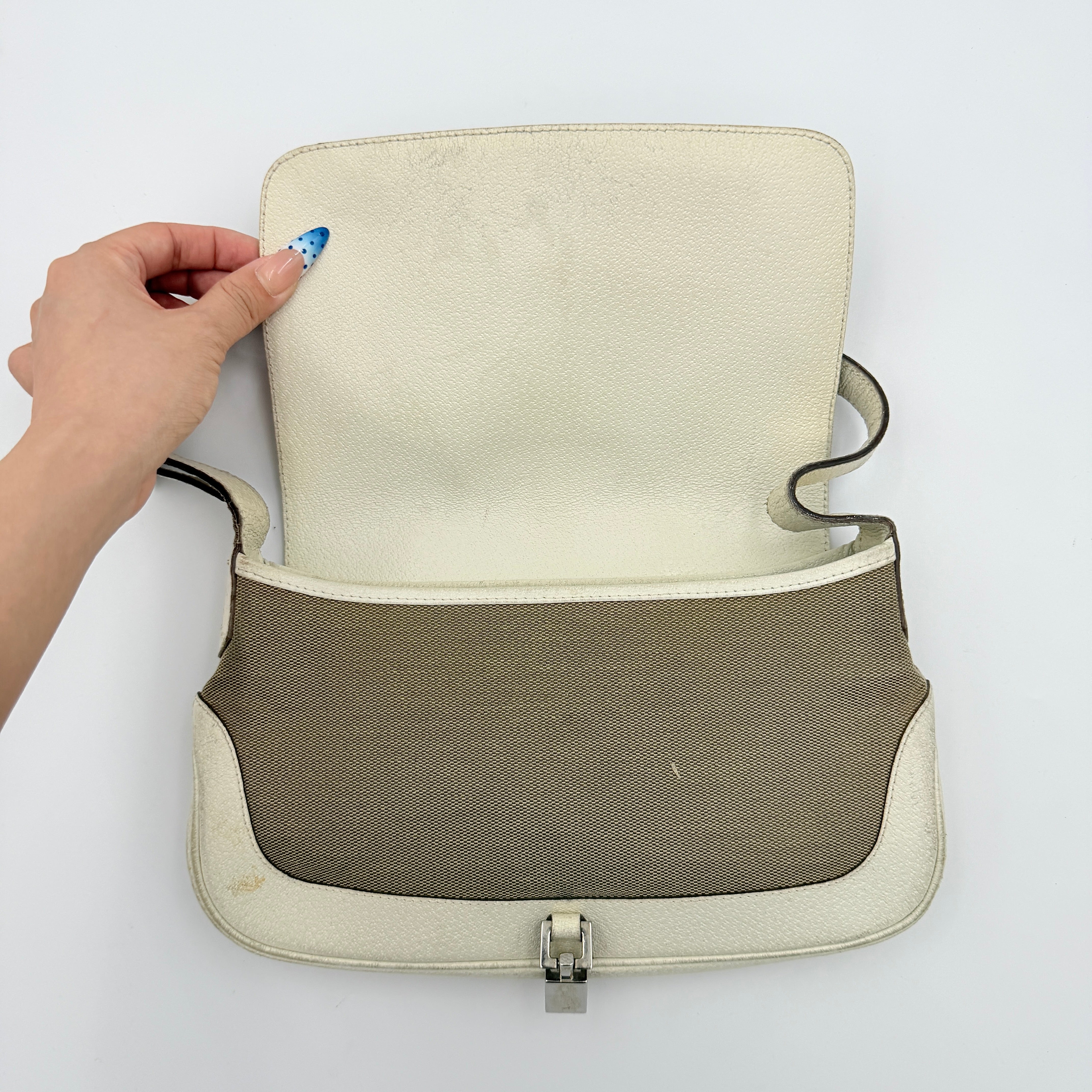 Gucci Jackie Shoulder Bag in brown canvas and white leather trim with silver-tone hardware, displayed against a clean background.