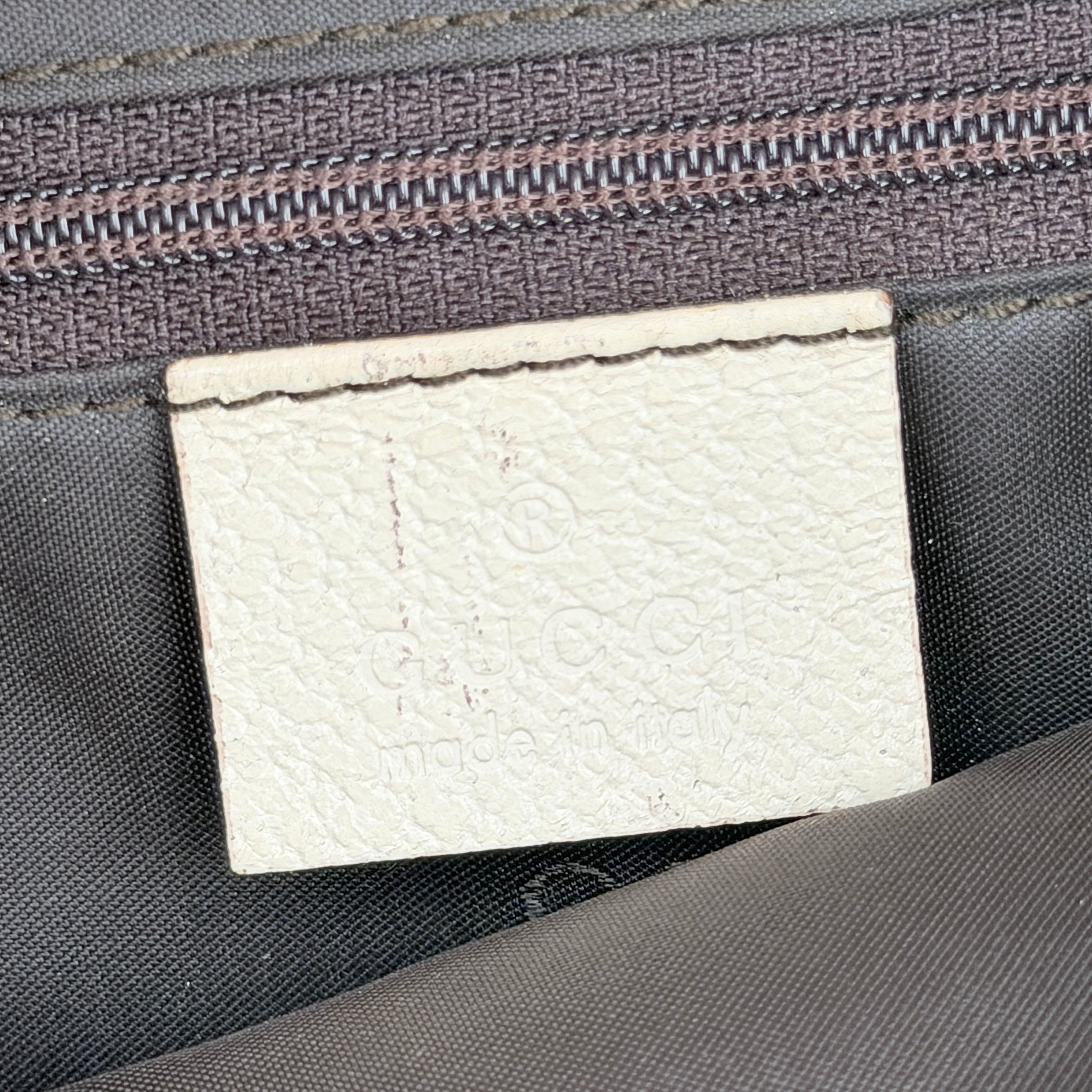 Gucci Jackie Shoulder Bag in brown canvas and white leather trim with silver-tone hardware, displayed against a clean background.