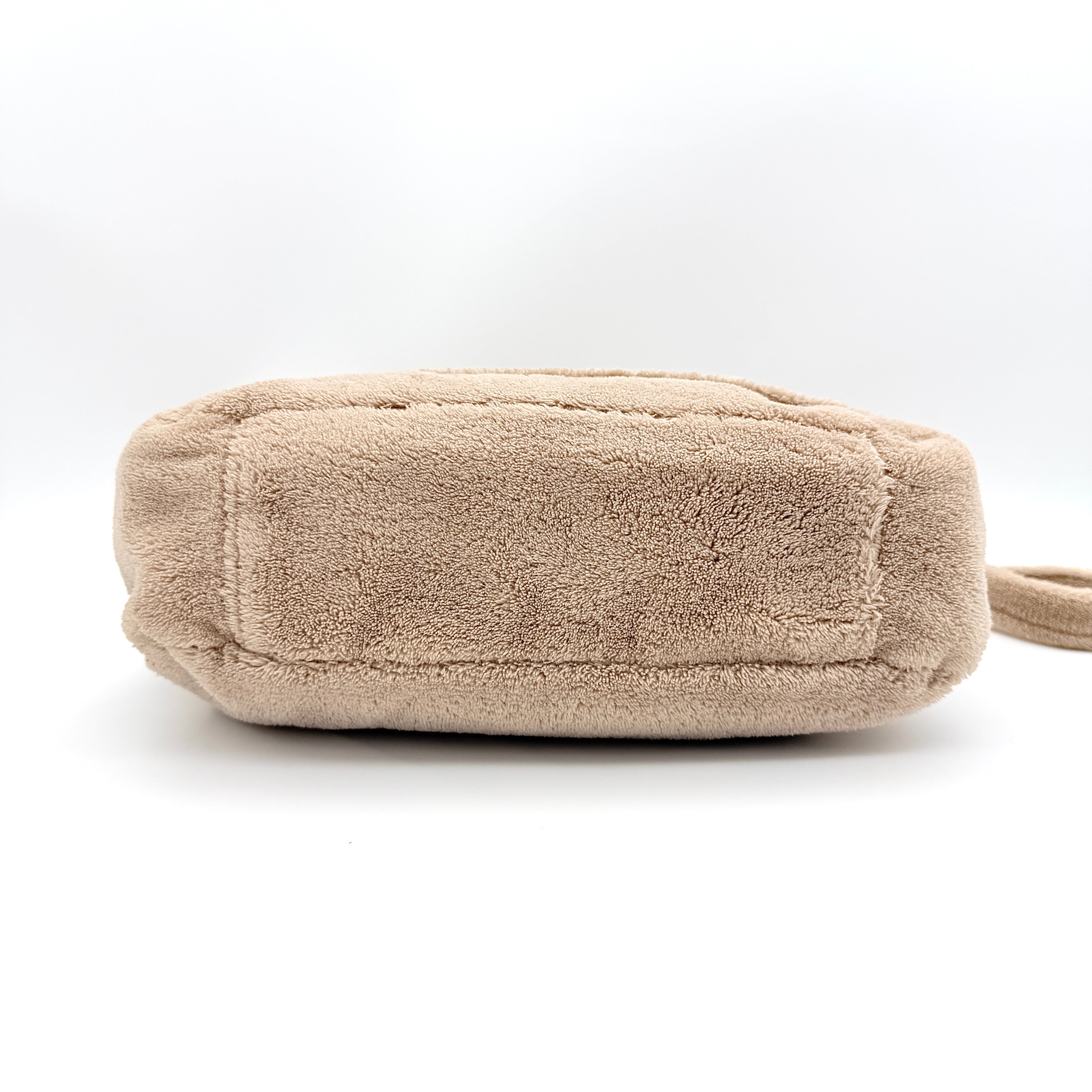 Chanel CC Precision Fragrance Line crossbody bag in beige terry cloth with white logo, shown with long strap.