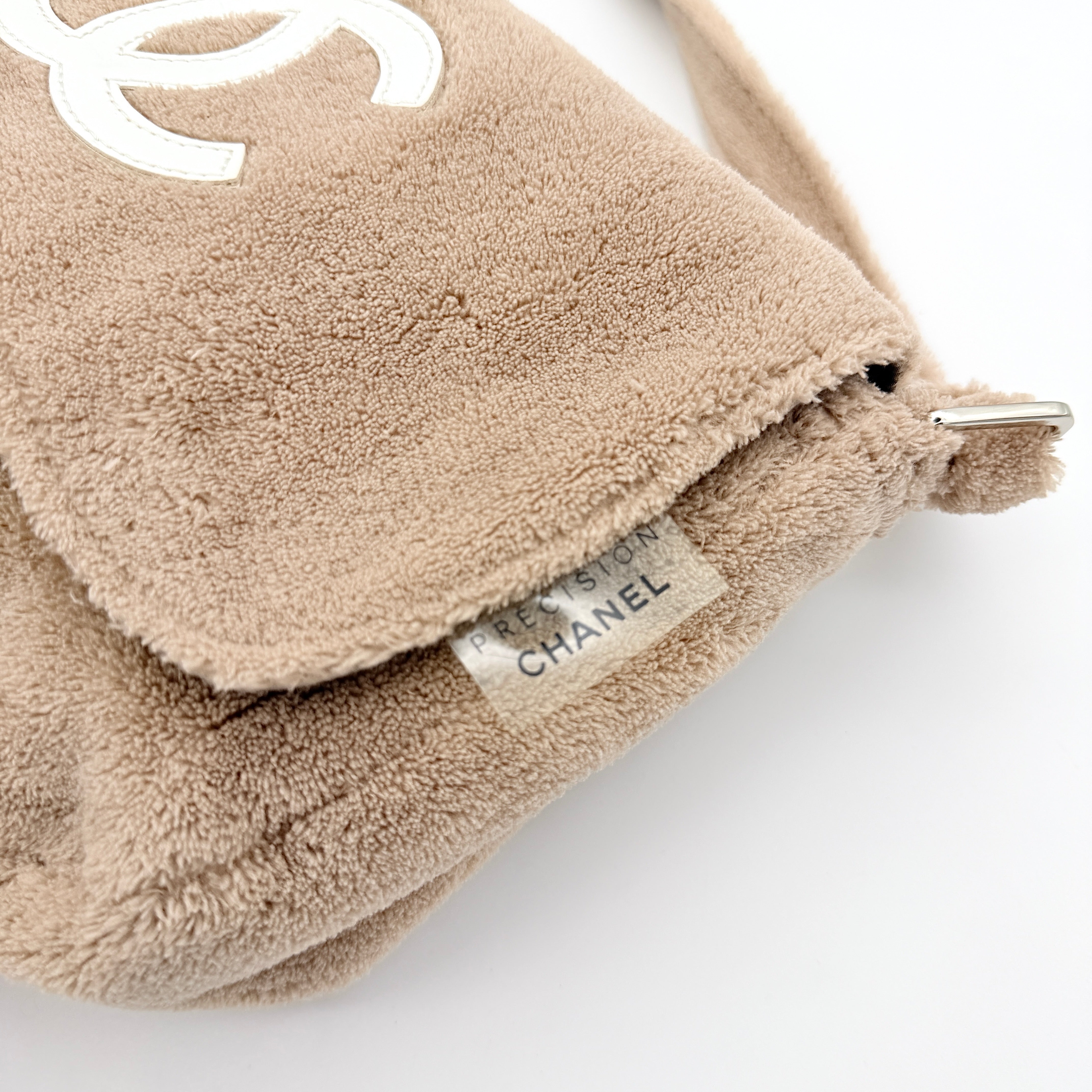Chanel CC Precision Fragrance Line crossbody bag in beige terry cloth with white logo, shown with long strap.