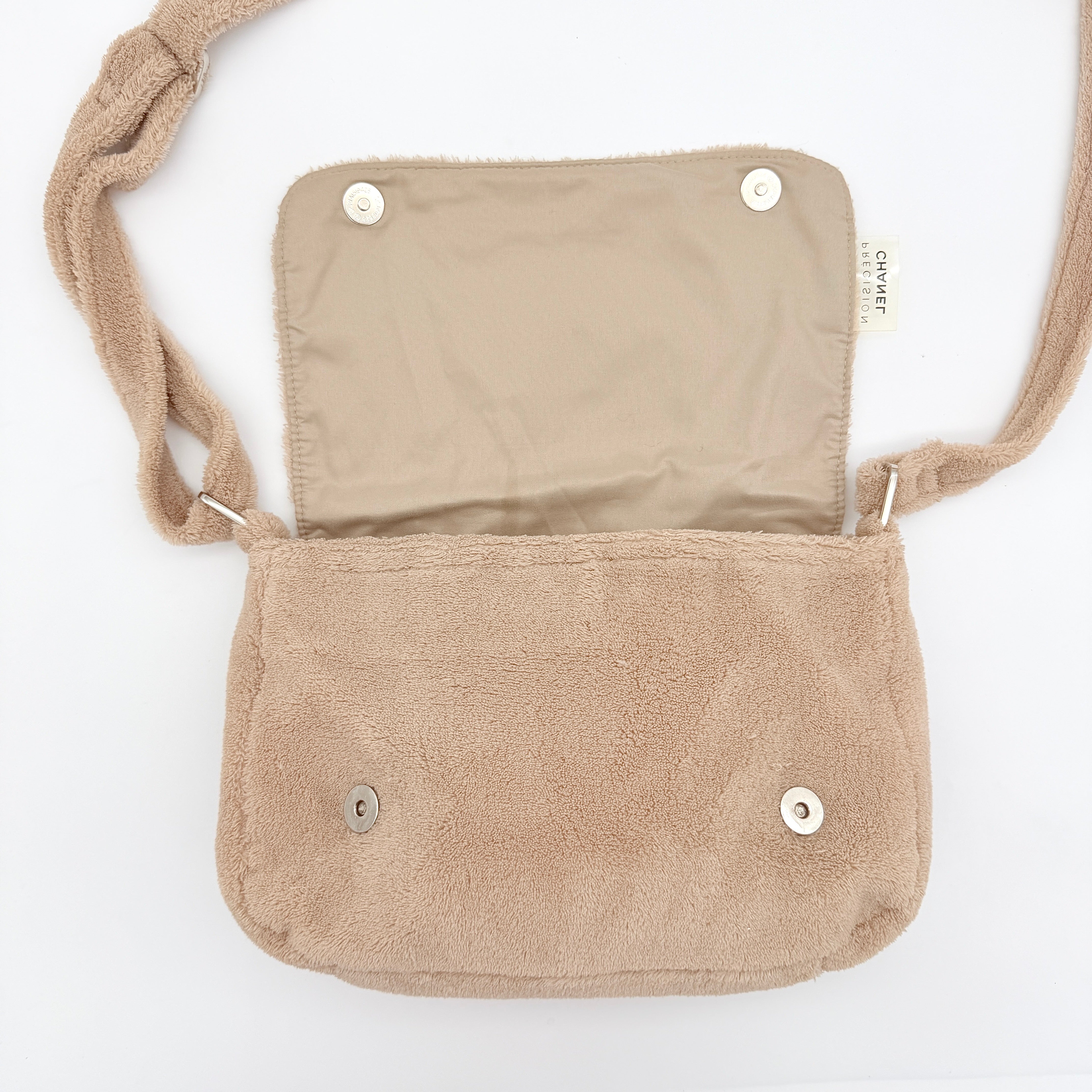 Chanel CC Precision Fragrance Line crossbody bag in beige terry cloth with white logo, shown with long strap.
