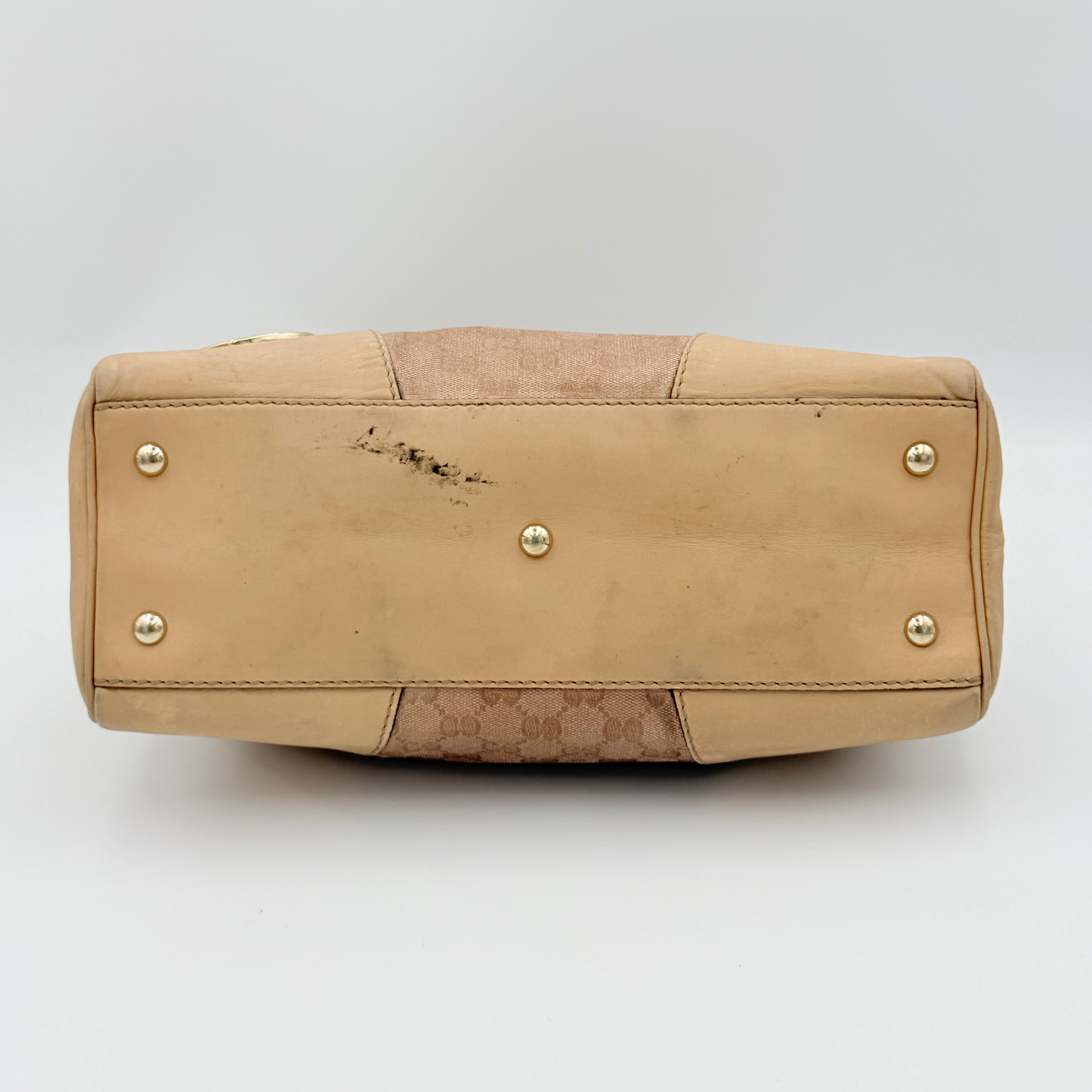Gucci GG Monogram Heart Lovely Boston Bag in beige and pink with gold heart logo and double handles, displayed against a plain background.