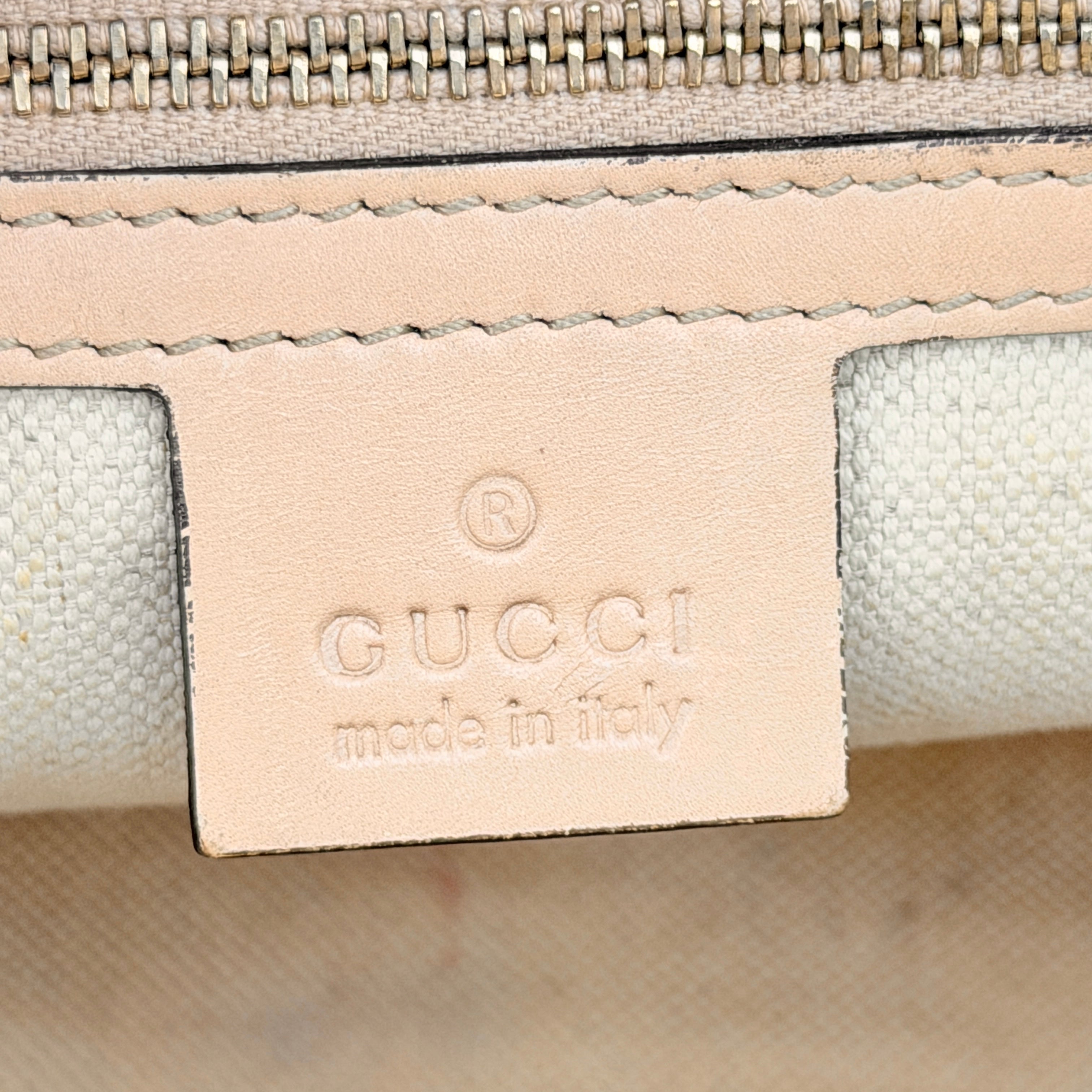 Gucci GG Monogram Heart Lovely Boston Bag in beige and pink with gold heart logo and double handles, displayed against a plain background.