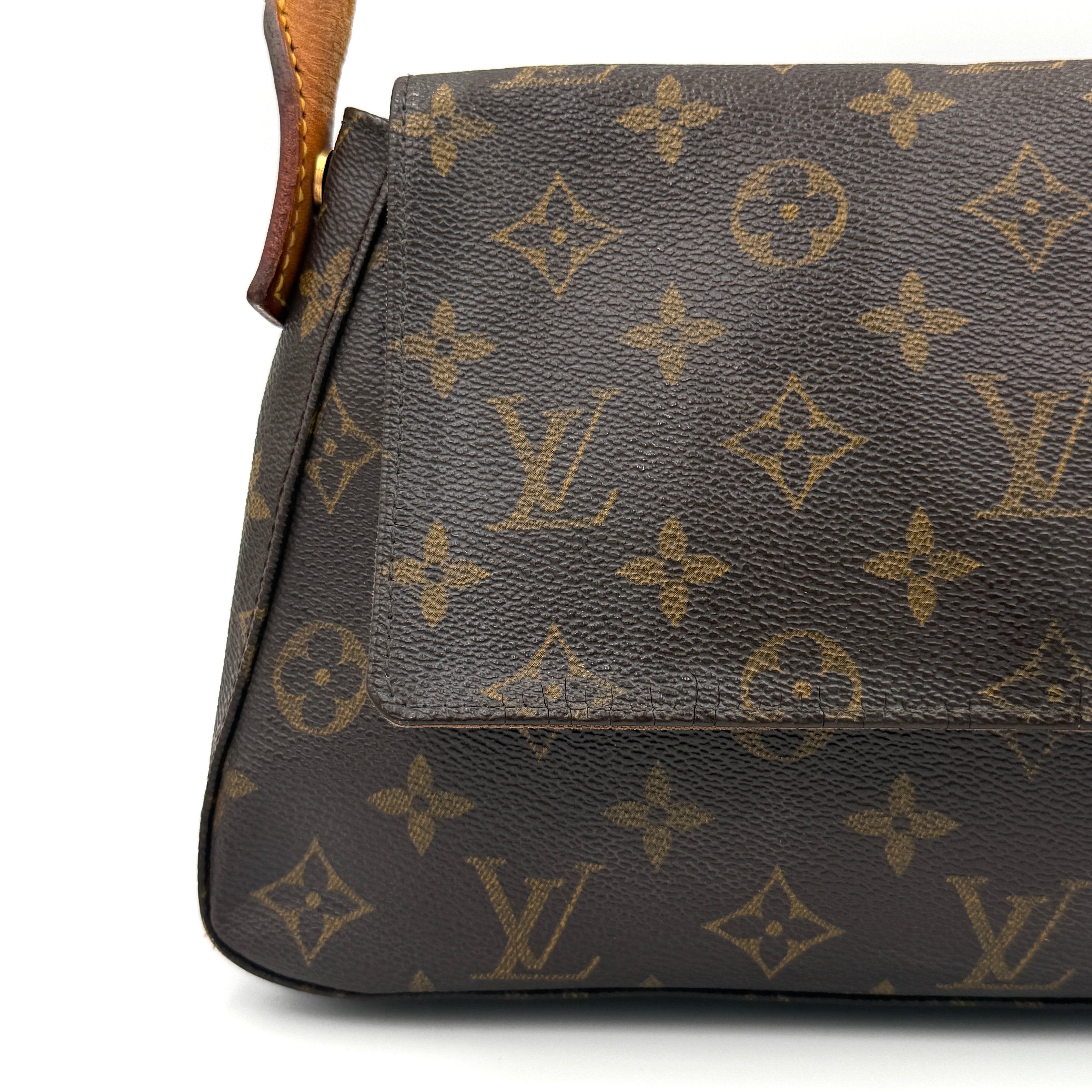 Louis Vuitton Monogram Mini Looping Shoulder Bag in brown monogram canvas with curved vachetta leather shoulder strap displayed upright.
