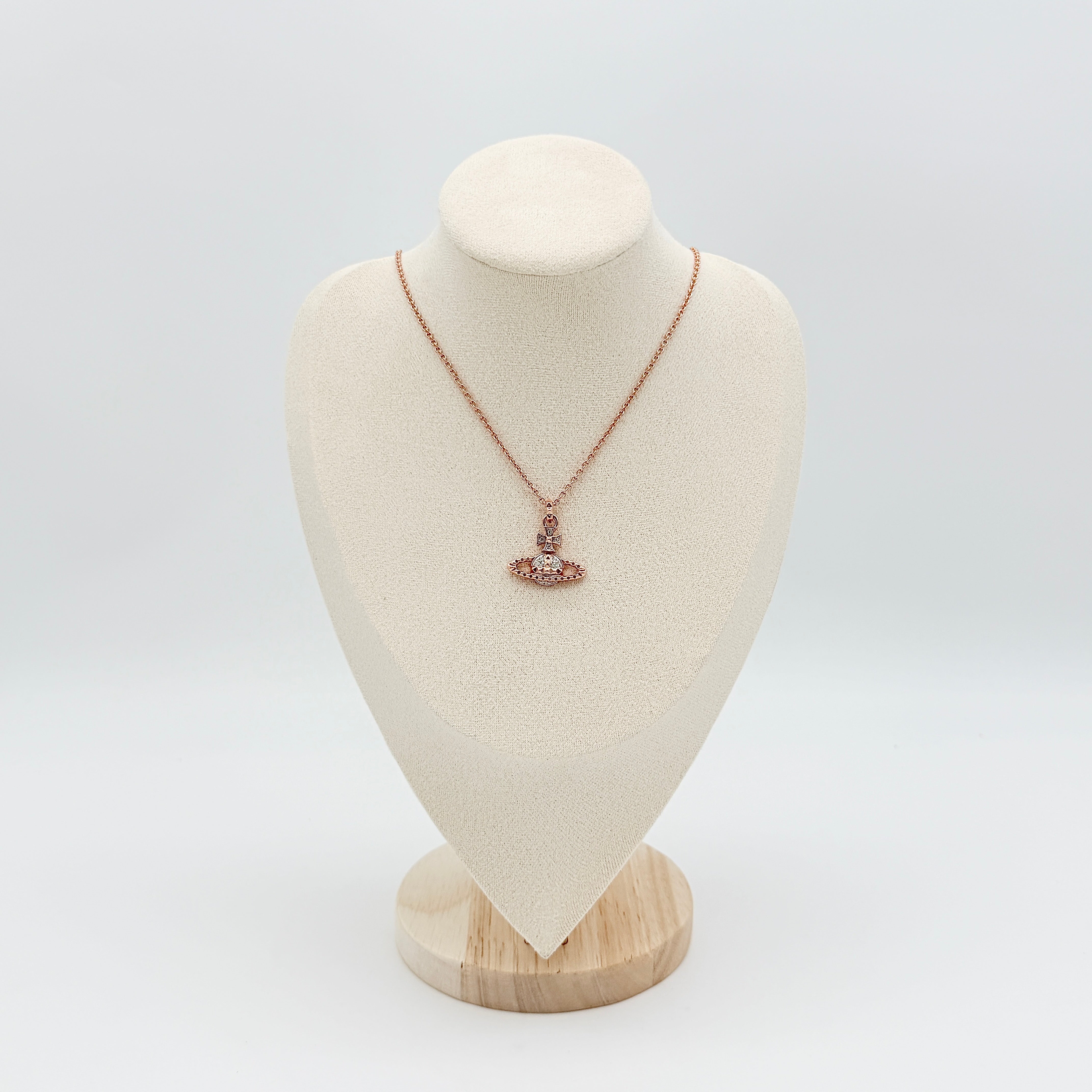 Vivienne Westwood rose gold Orb necklace with rhinestone accents displayed on a white background.