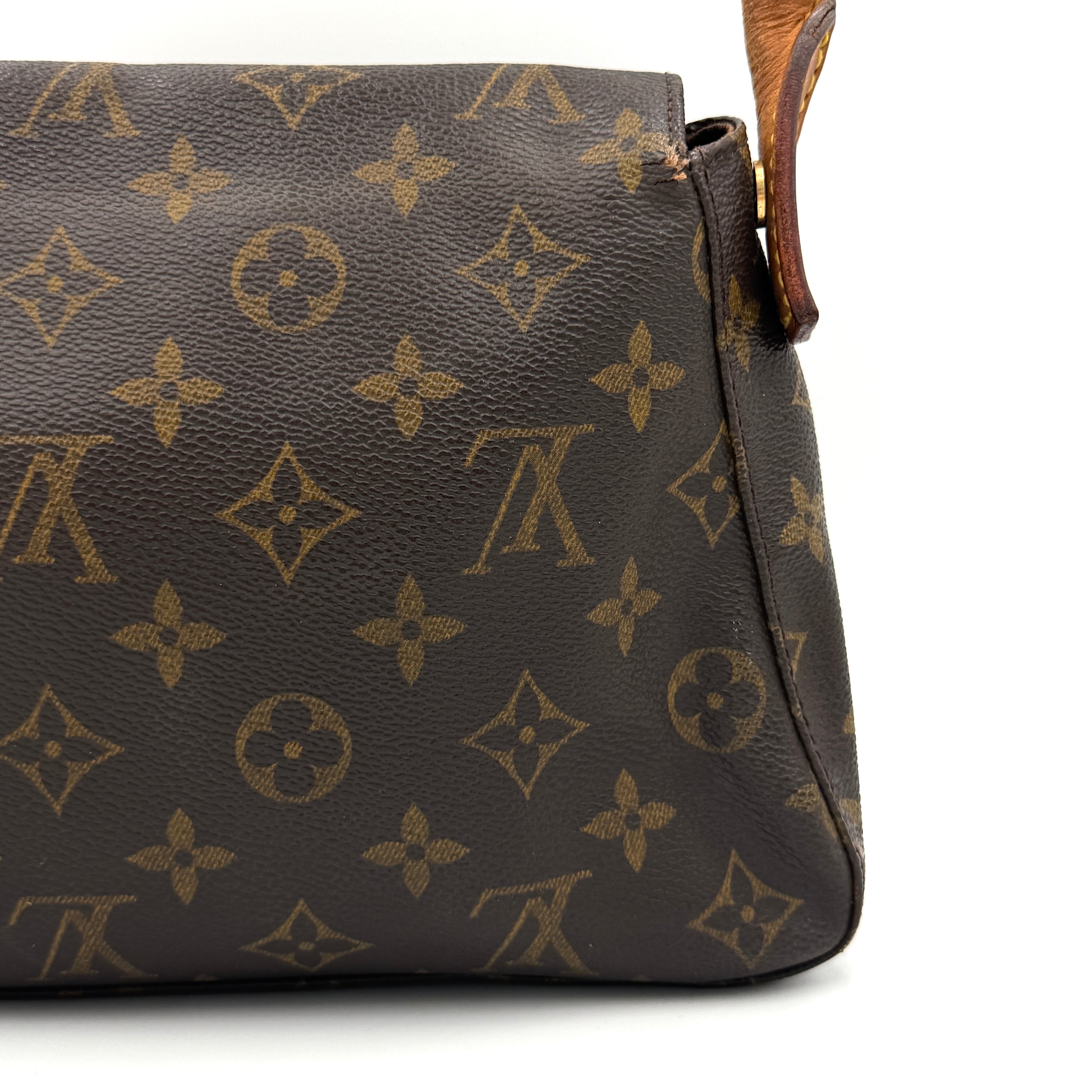 Louis Vuitton Monogram Mini Looping Shoulder Bag in brown monogram canvas with curved vachetta leather shoulder strap displayed upright.