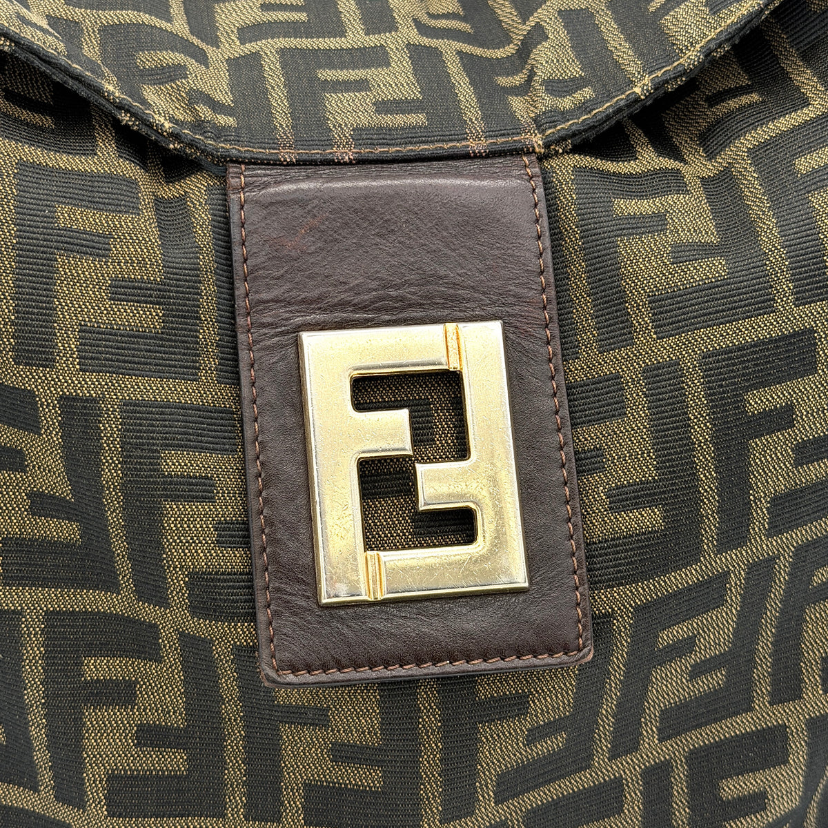 Fendi FF Zucca Mamma Baguette Shoulder Bag in brown monogram canvas with leather strap and gold-tone hardware, photographed upright.