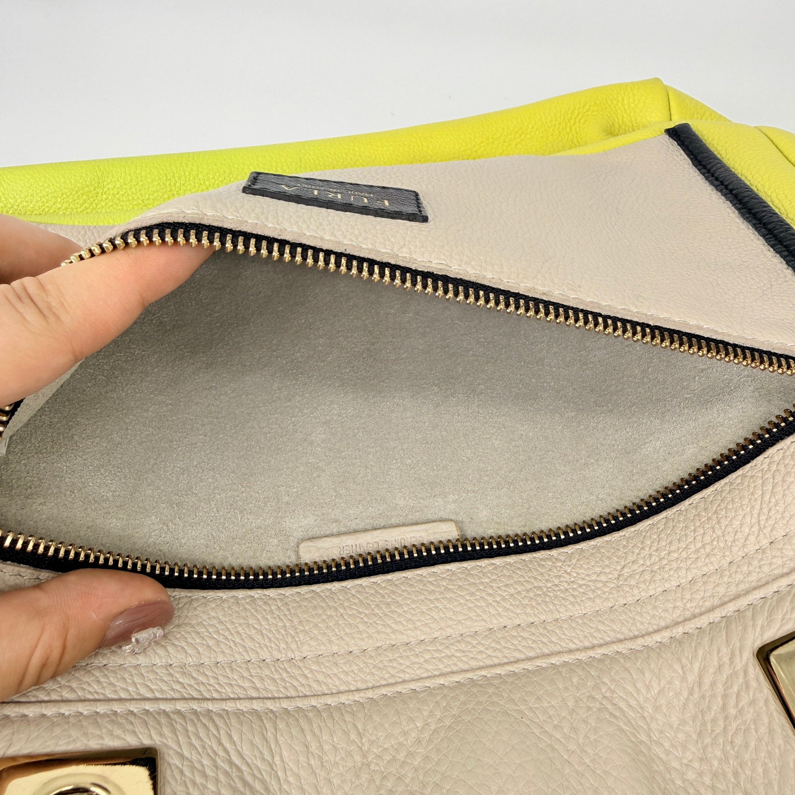 Furla Shopper Tote in neon yellow and beige grained leather with black handles and gold-tone hardware.