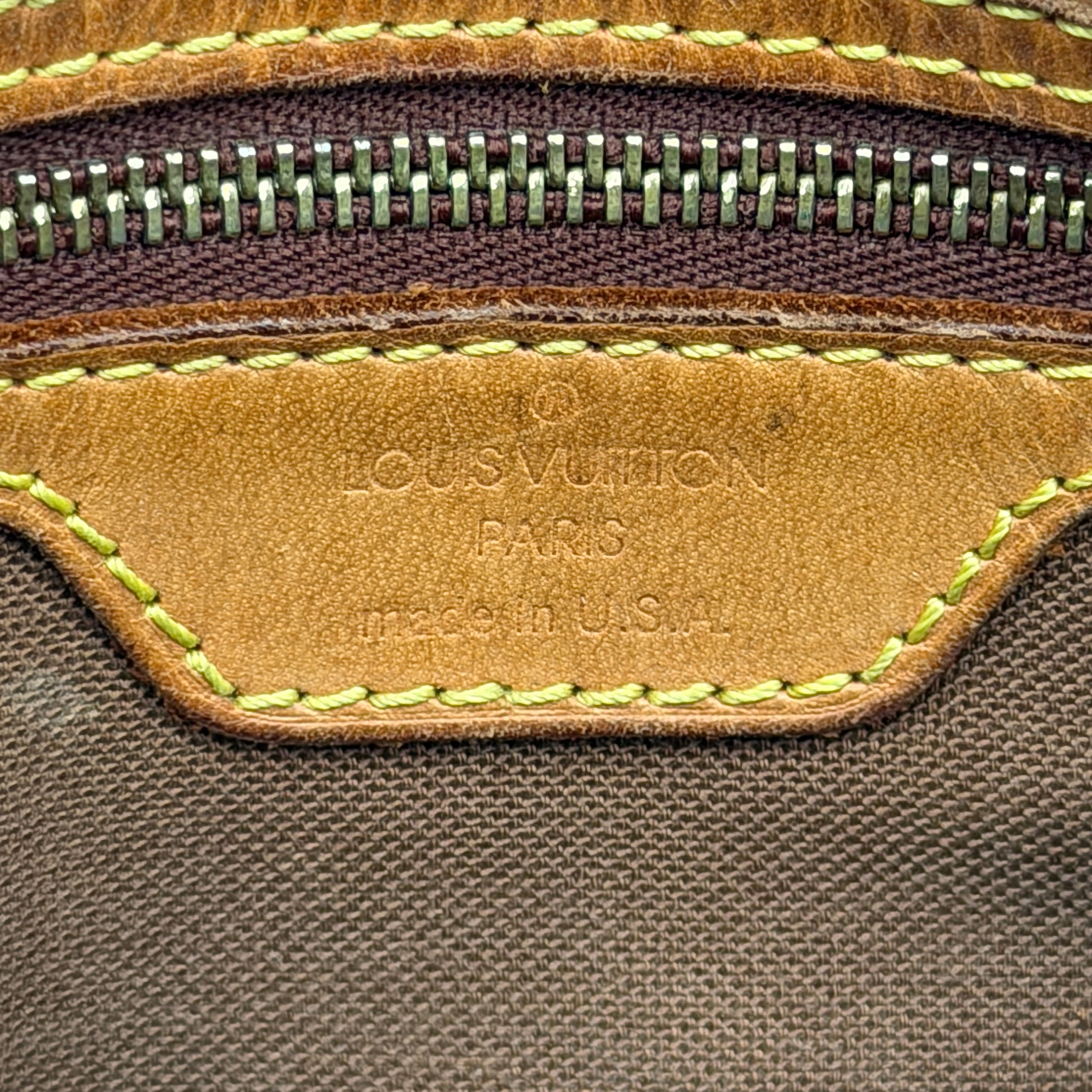 Louis Vuitton Monogram Mini Looping Shoulder Bag in brown monogram canvas with curved vachetta leather shoulder strap displayed upright.