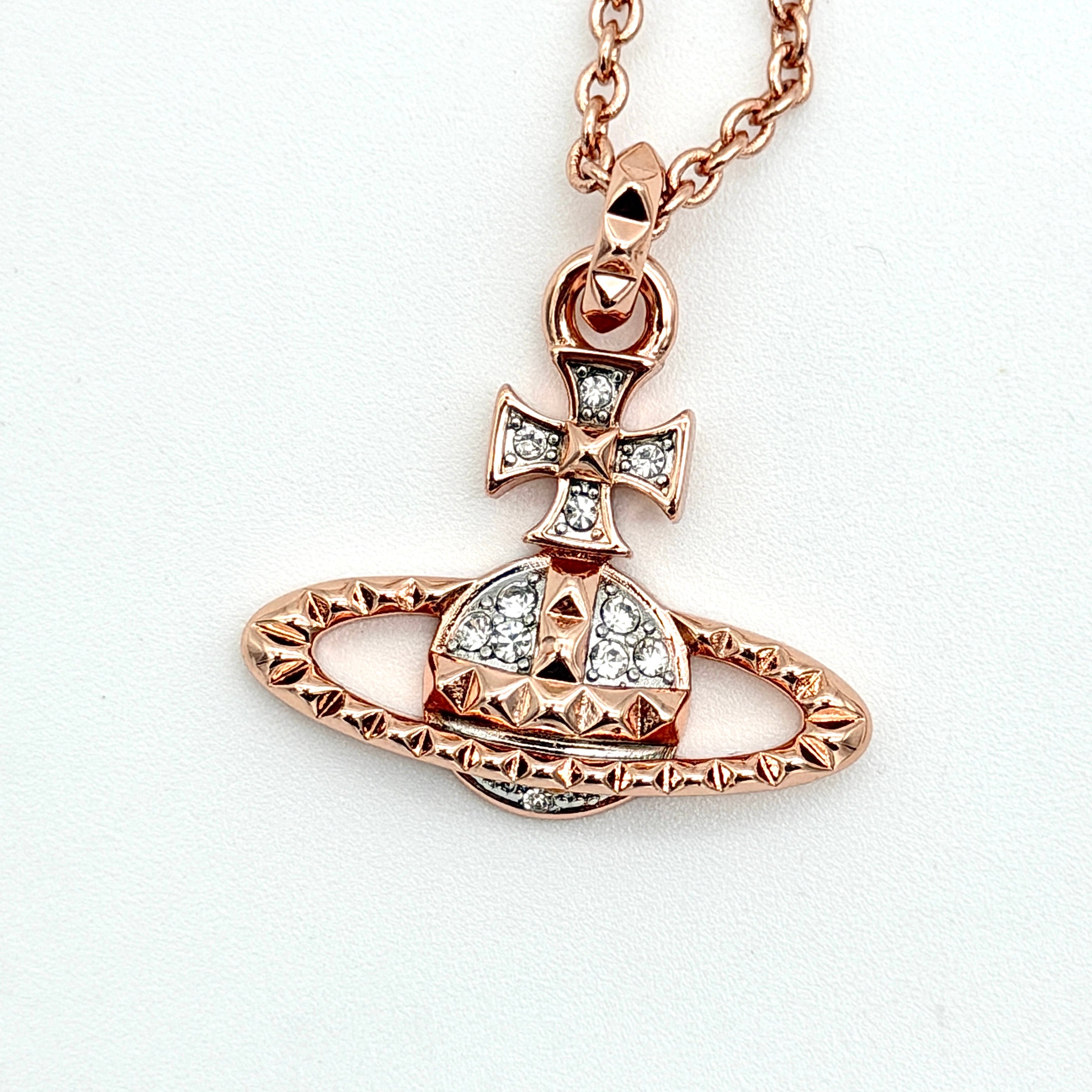 Vivienne Westwood rose gold Orb necklace with rhinestone accents displayed on a white background.