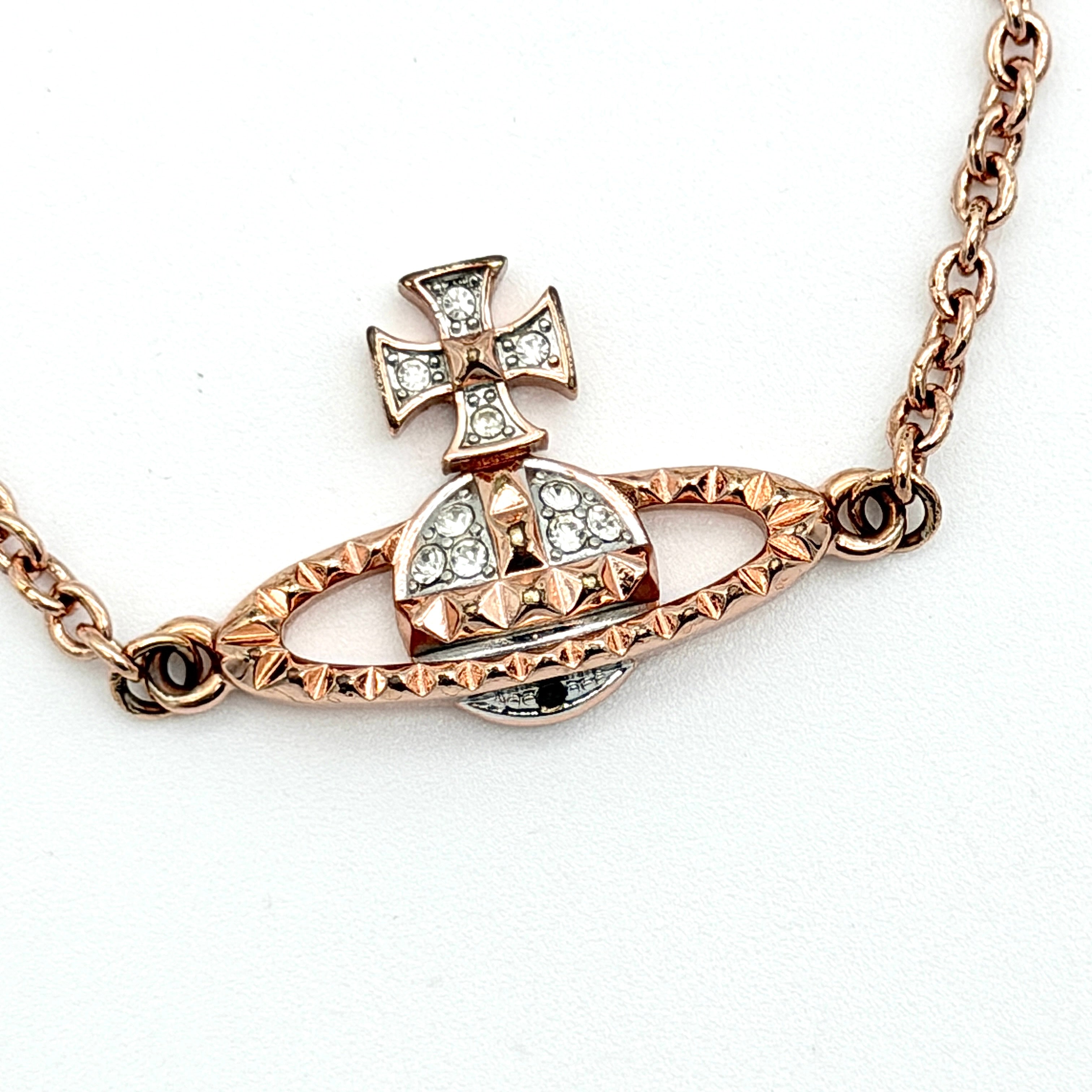 Vivienne Westwood 3D Orb rhinestone bracelet in rose gold with crystal accents and a fine chain.