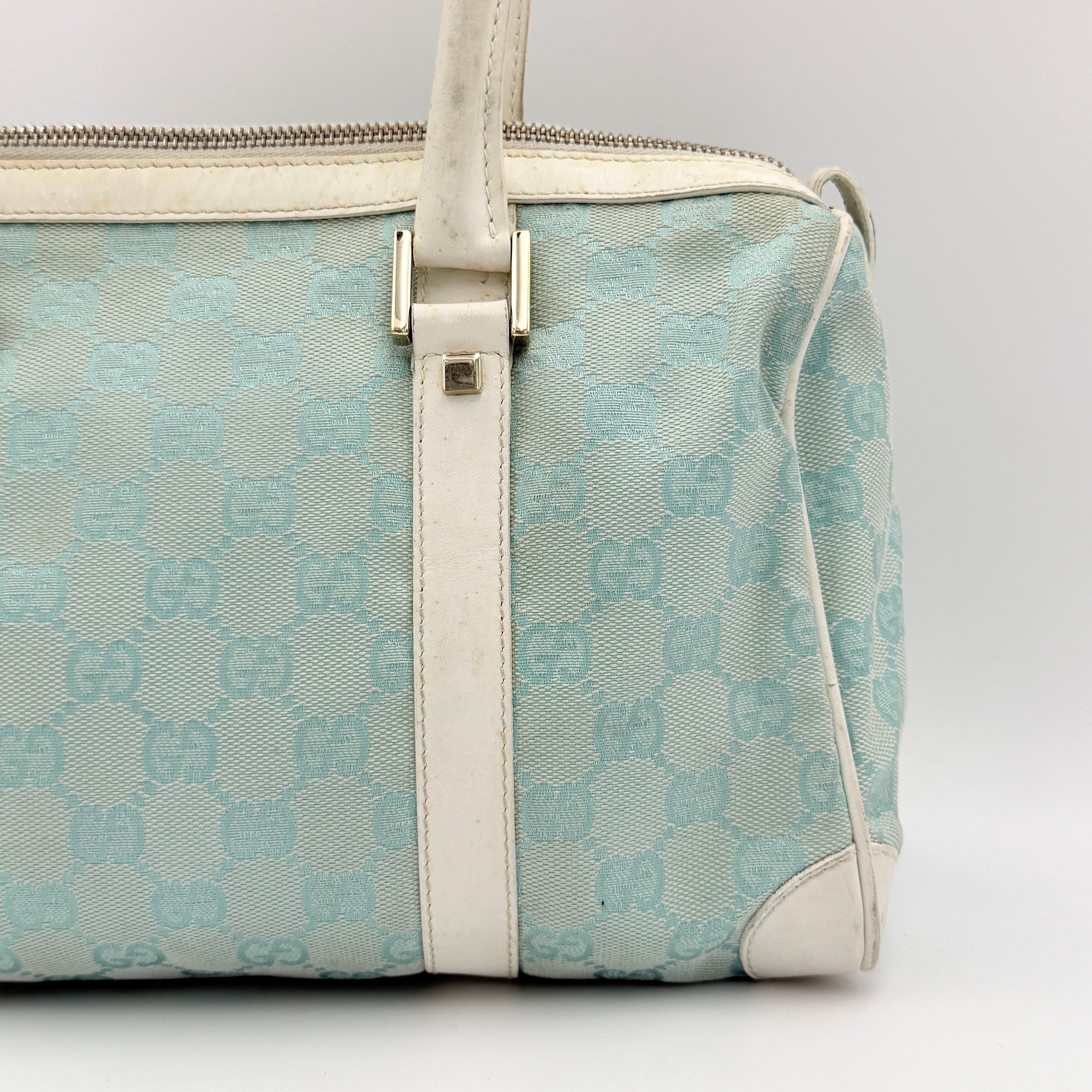 Gucci GG Monogram Boston Shoulder Bag in blue and white canvas with white leather trim, structured silhouette and double top handles.