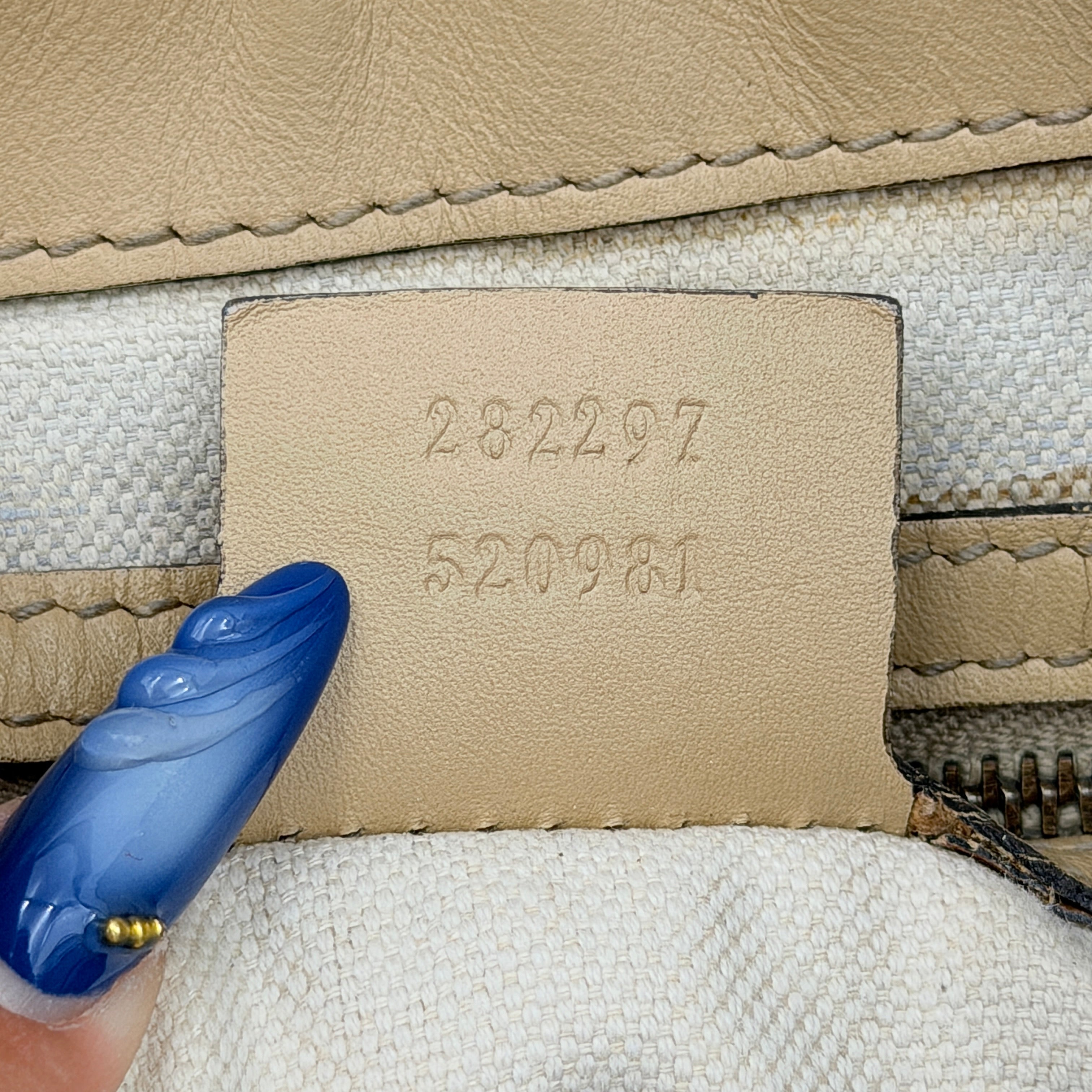 Gucci GG Monogram Guccissima Scarlett Shoulder Bag in beige embossed leather with gold hardware and single top handle.