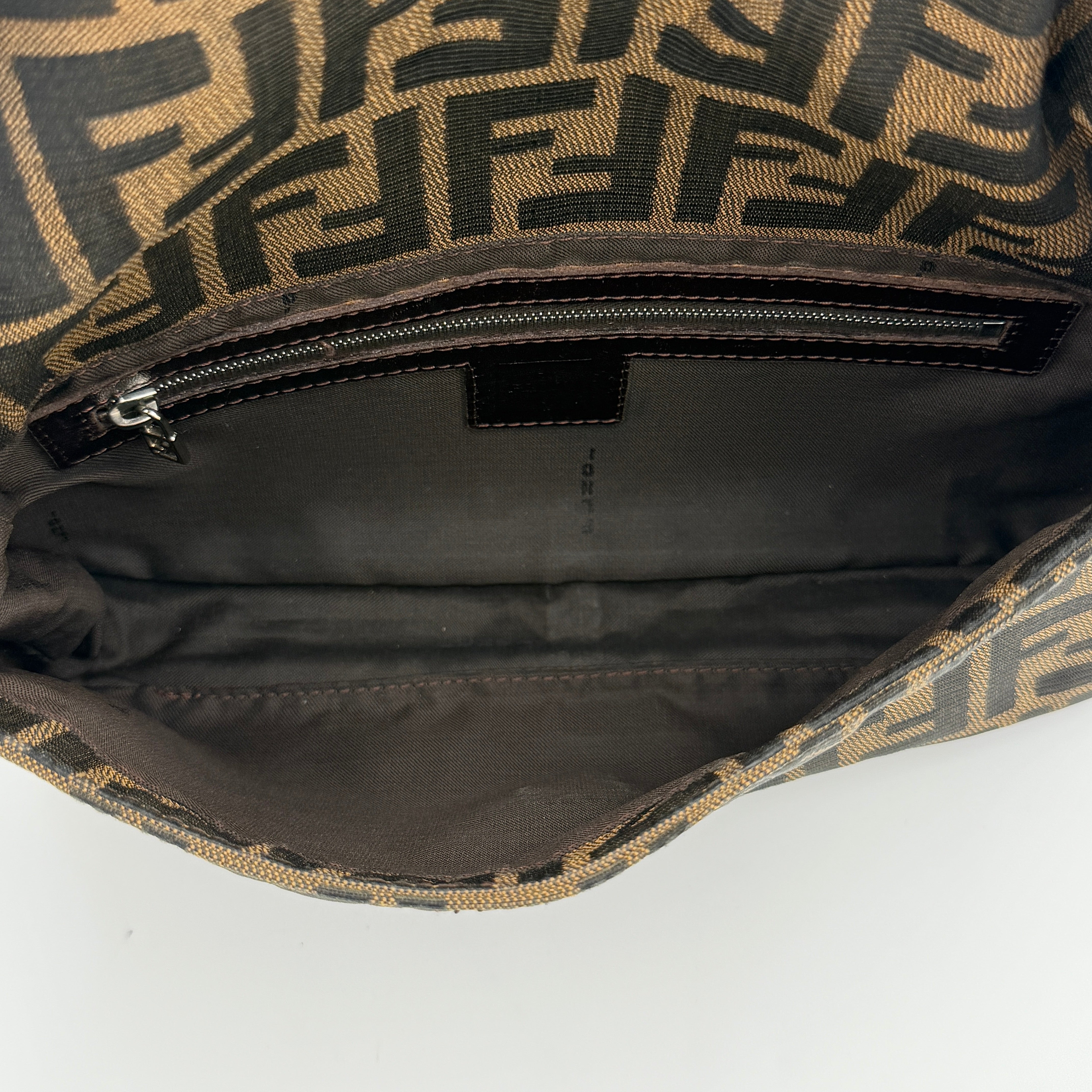 Fendi Zucca Print Baguette Bag in brown monogram canvas with silver-tone FF clasp and leather trim shown against a white background.