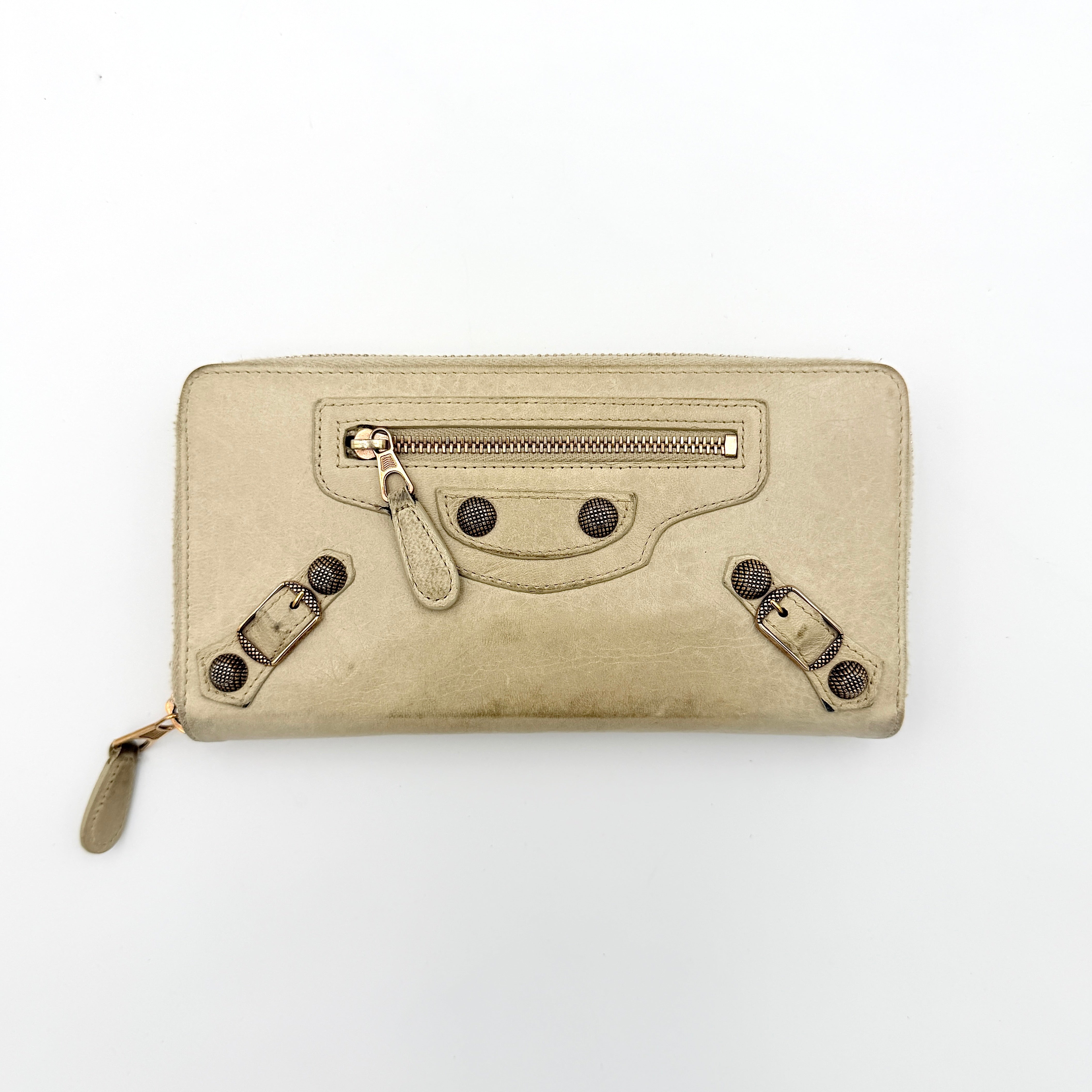 Balenciaga Motorcycle Studded Long Wallet in beige leather with signature studs and front zip pocket, displayed against a clean background.
