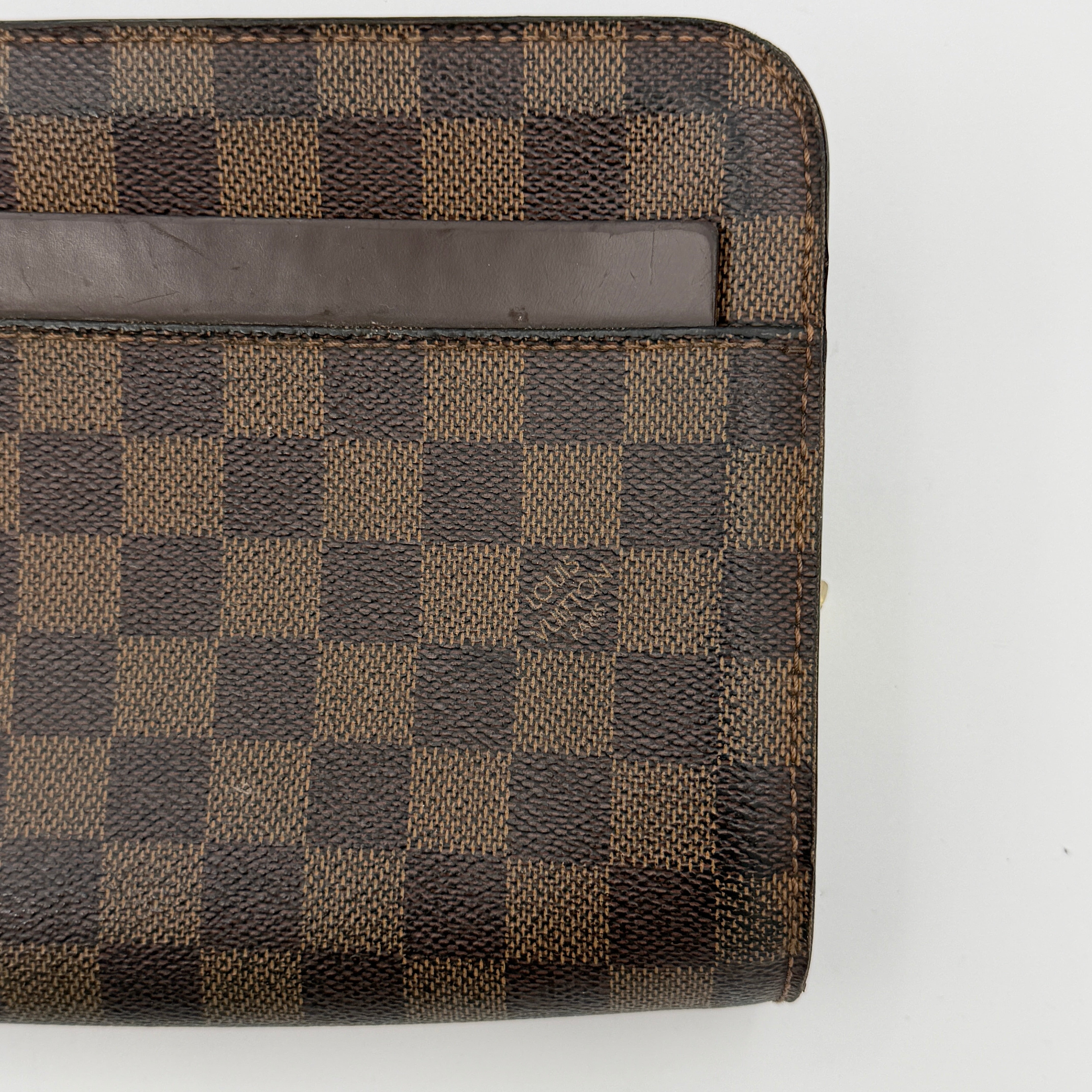 Louis Vuitton Saint Louis Damier Clutch Bag in brown Damier Ebene canvas with chocolate leather trim and gold-tone hardware, photographed on white background.