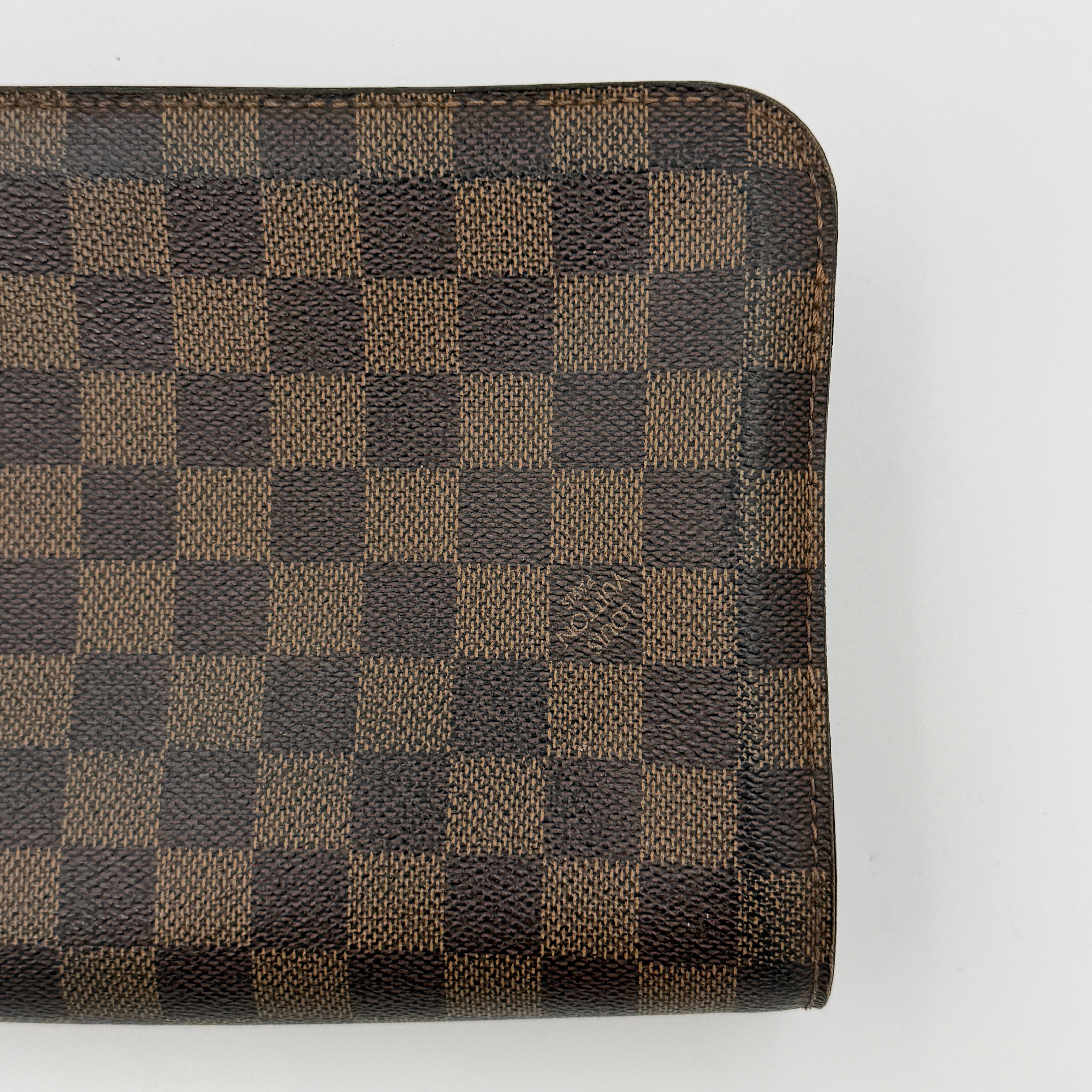 Louis Vuitton Saint Louis Damier Clutch Bag in brown Damier Ebene canvas with chocolate leather trim and gold-tone hardware, photographed on white background.
