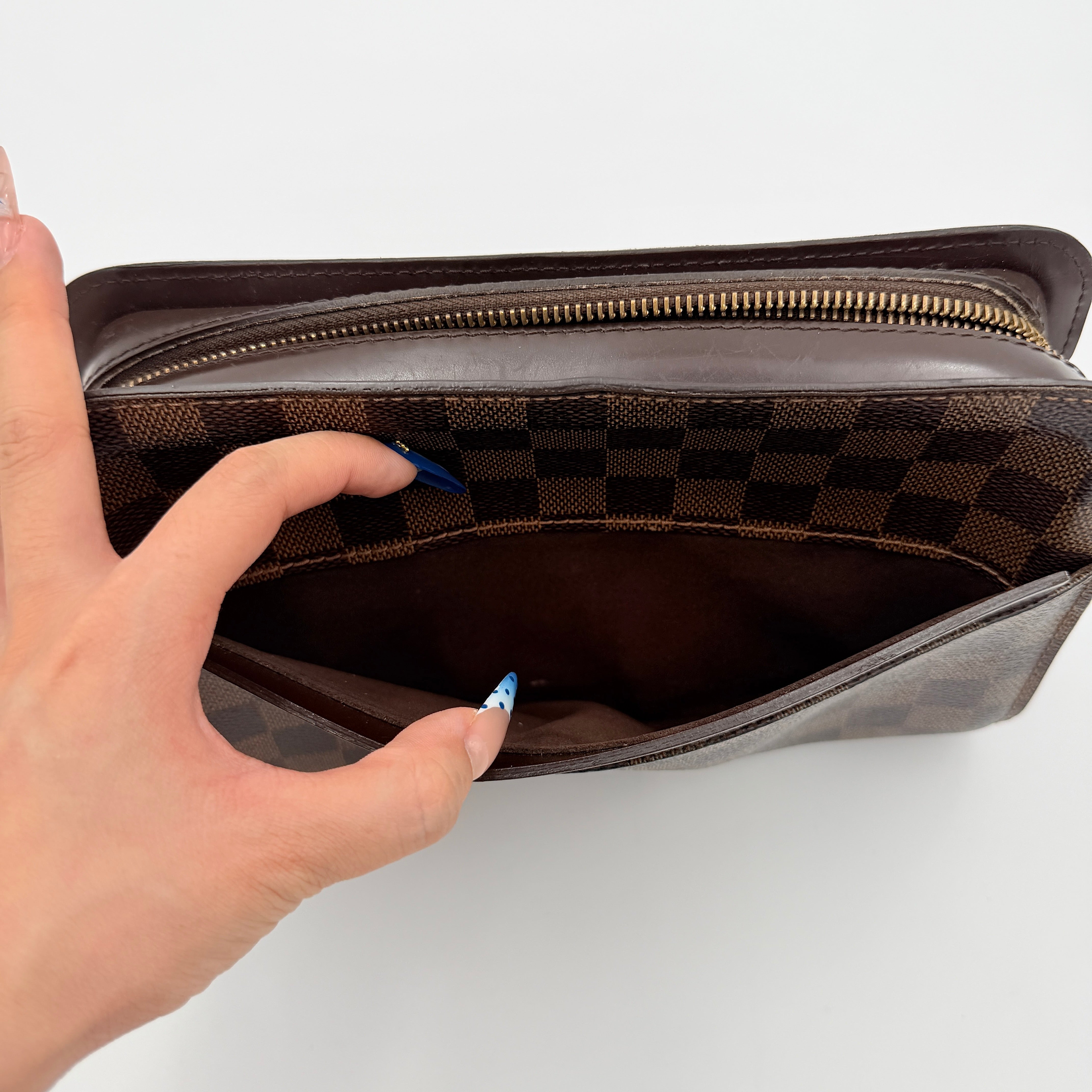 Louis Vuitton Saint Louis Damier Clutch Bag in brown Damier Ebene canvas with chocolate leather trim and gold-tone hardware, photographed on white background.