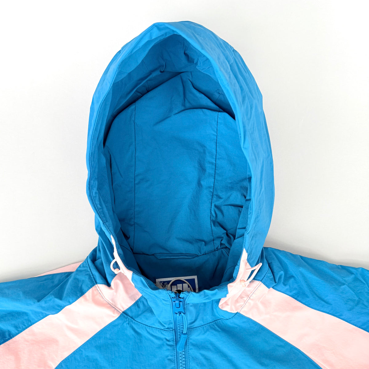 (L) Undefeated Lightweight Hooded Windbreaker Jacket Blue/Pink