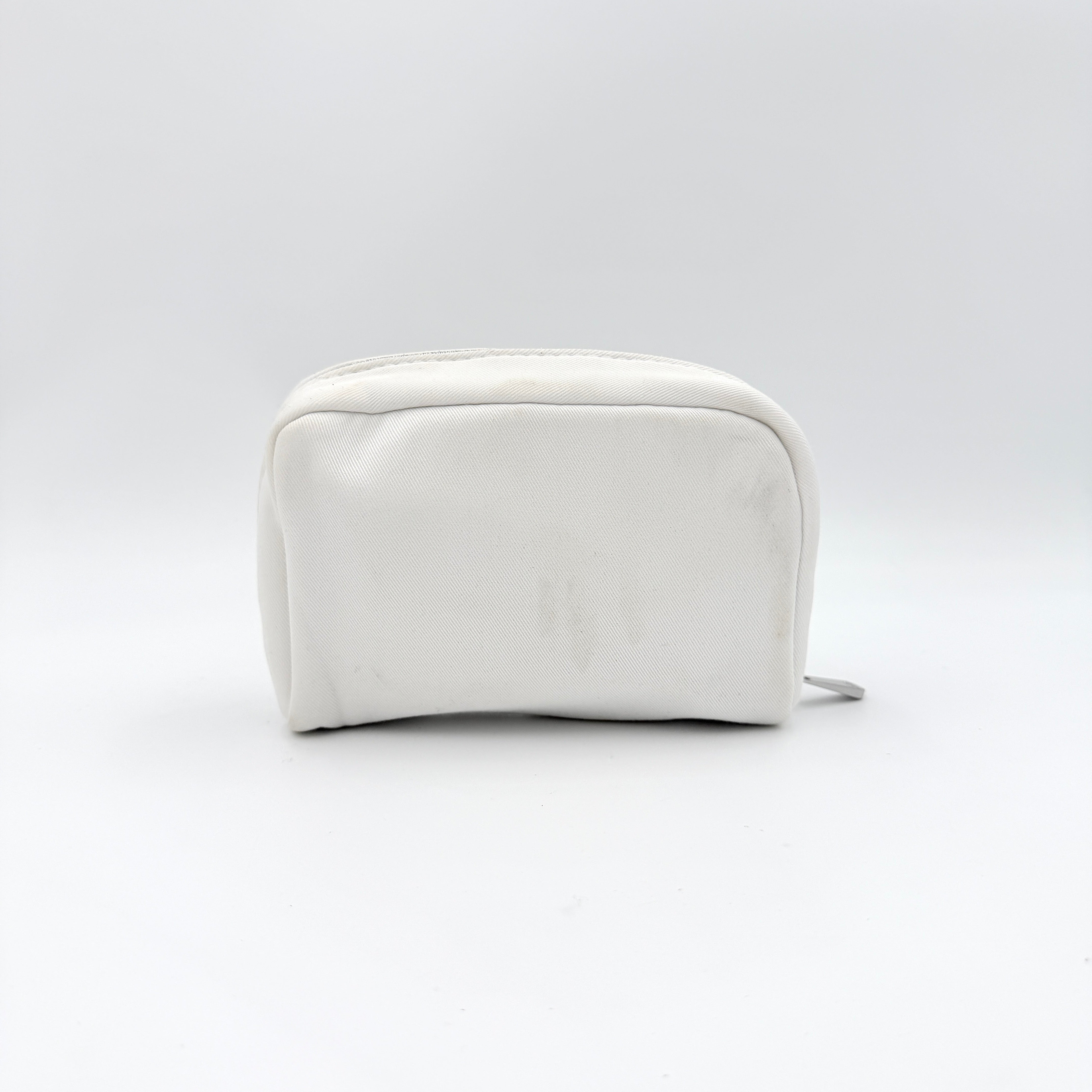 Crisp white Dior Beauty Logo Pouch with an embroidered logo and sleek silver-tone zipper, showcased against a minimalist backdrop.