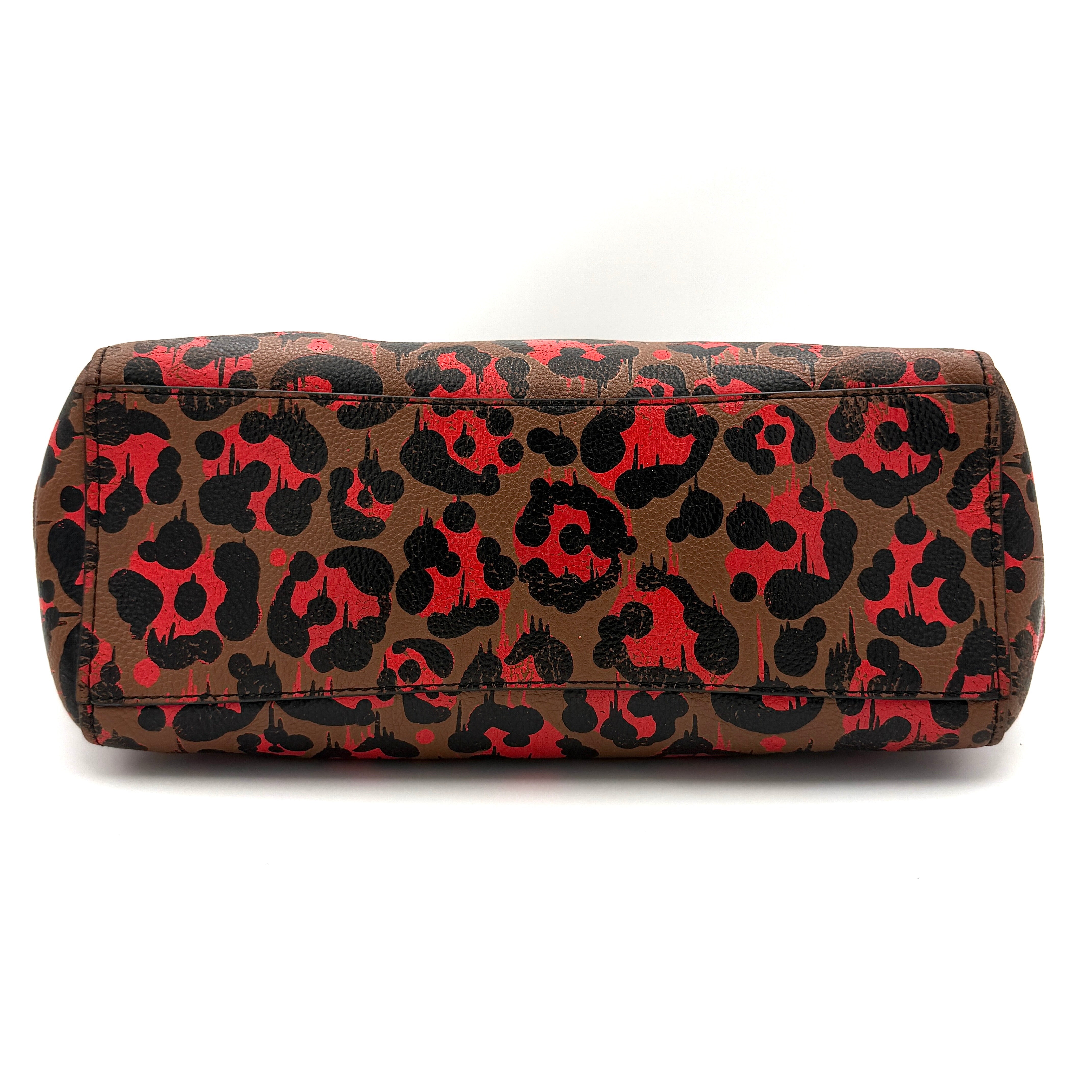 Coach City Tote in brown coated canvas, drenched in a vivid red and black leopard print, with black leather handles and silver hardware details.