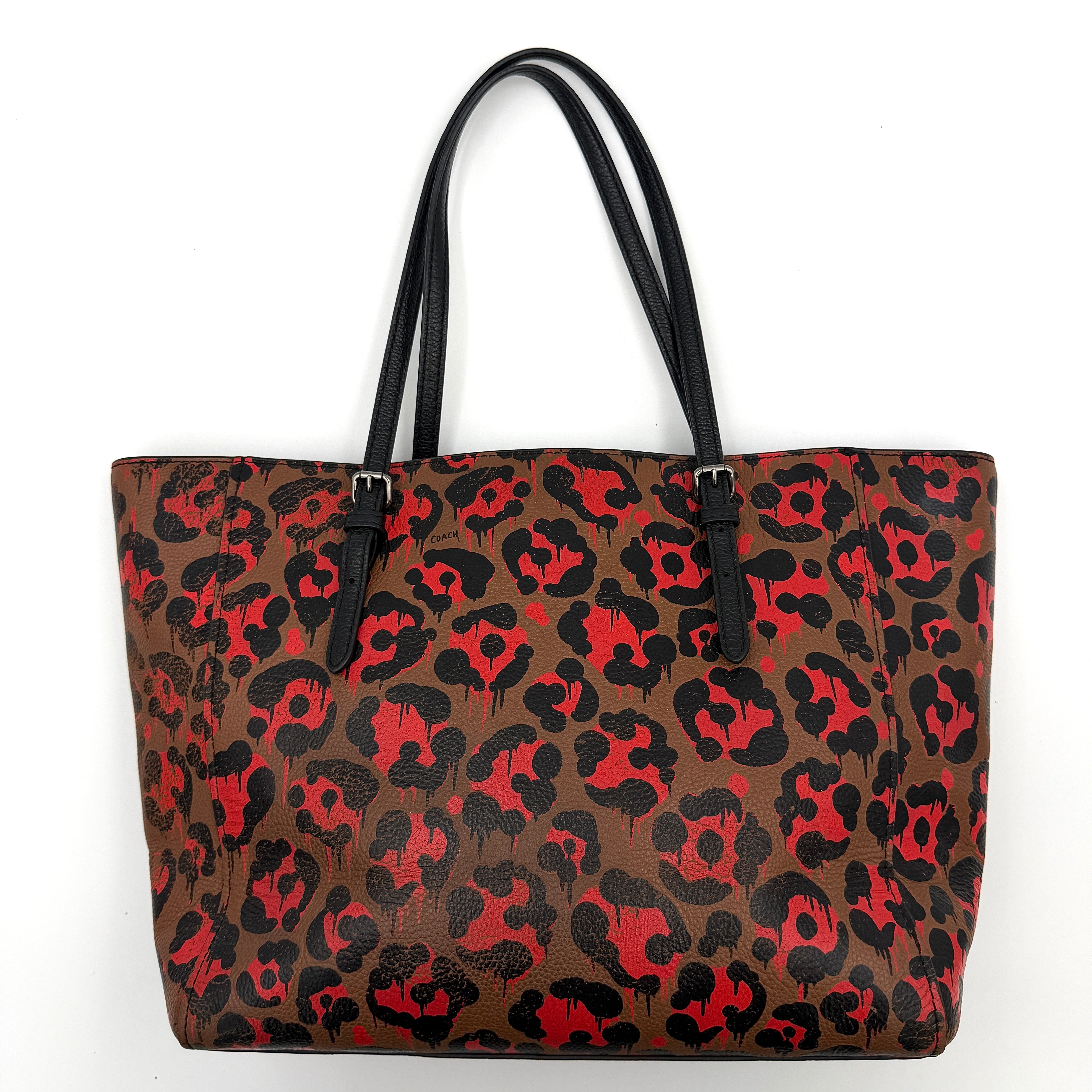 Coach City Tote in brown coated canvas, drenched in a vivid red and black leopard print, with black leather handles and silver hardware details.