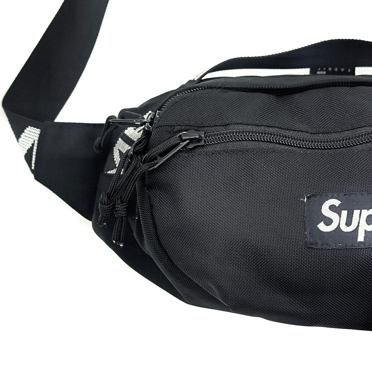 Supreme Box Logo Waist Bag in black Cordura fabric with white logo and logo-woven adjustable strap, laid flat to show its front design.