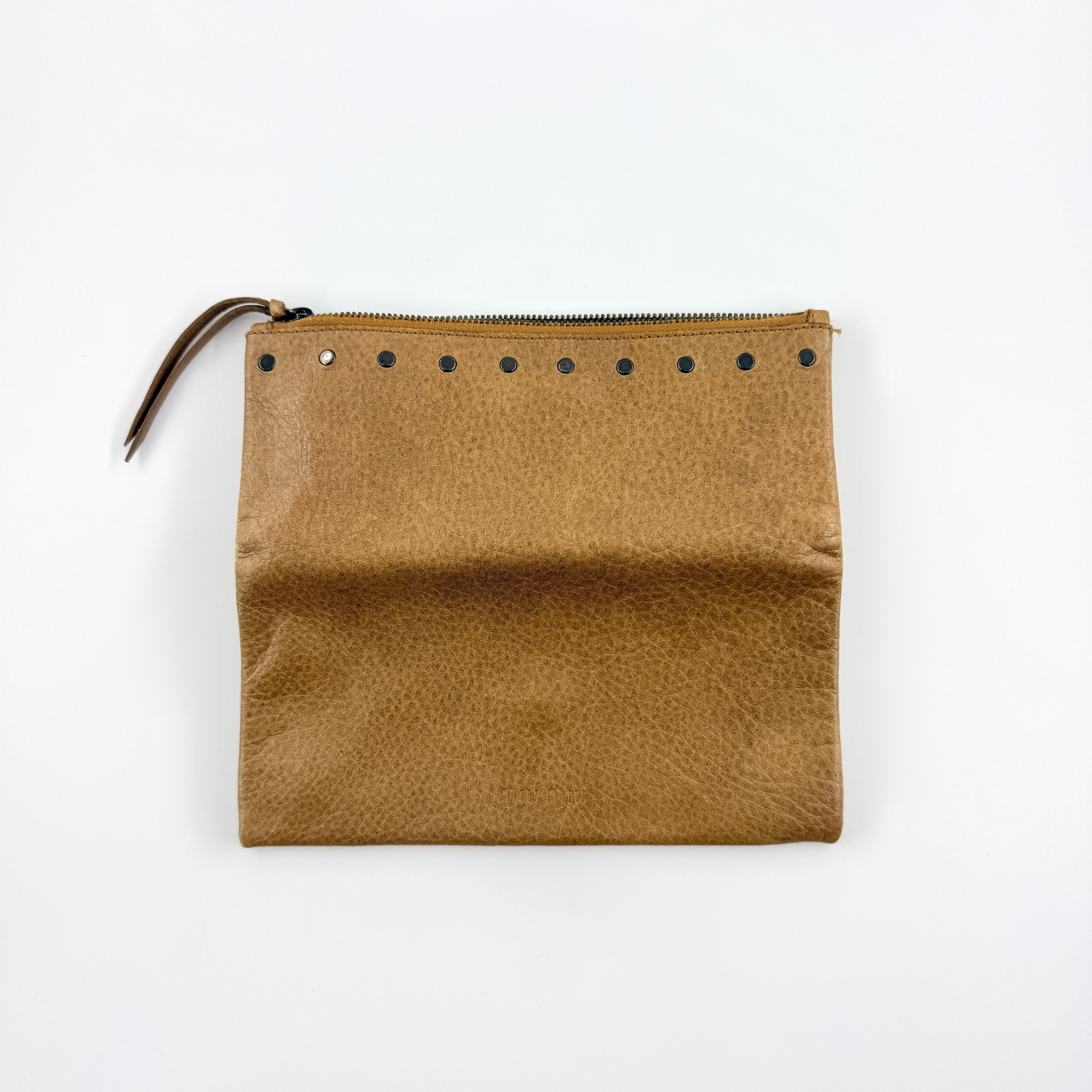 Miu Miu brown textured leather foldover pouch with matte black studs, zip closure, and slim silhouette.
