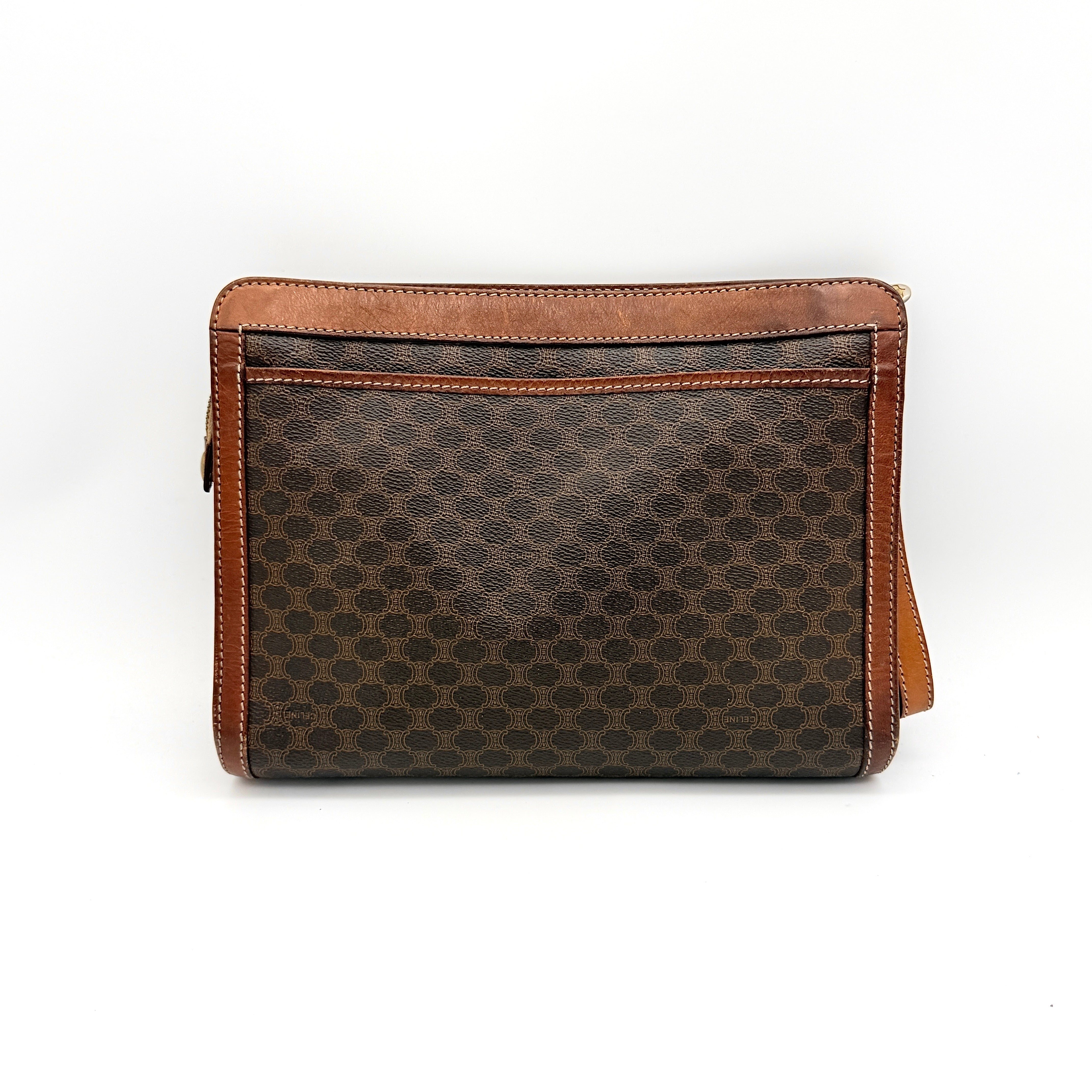 Front view of the Celine Triomphe Macadam clutch bag in brown canvas with tan leather trim and zip pocket.