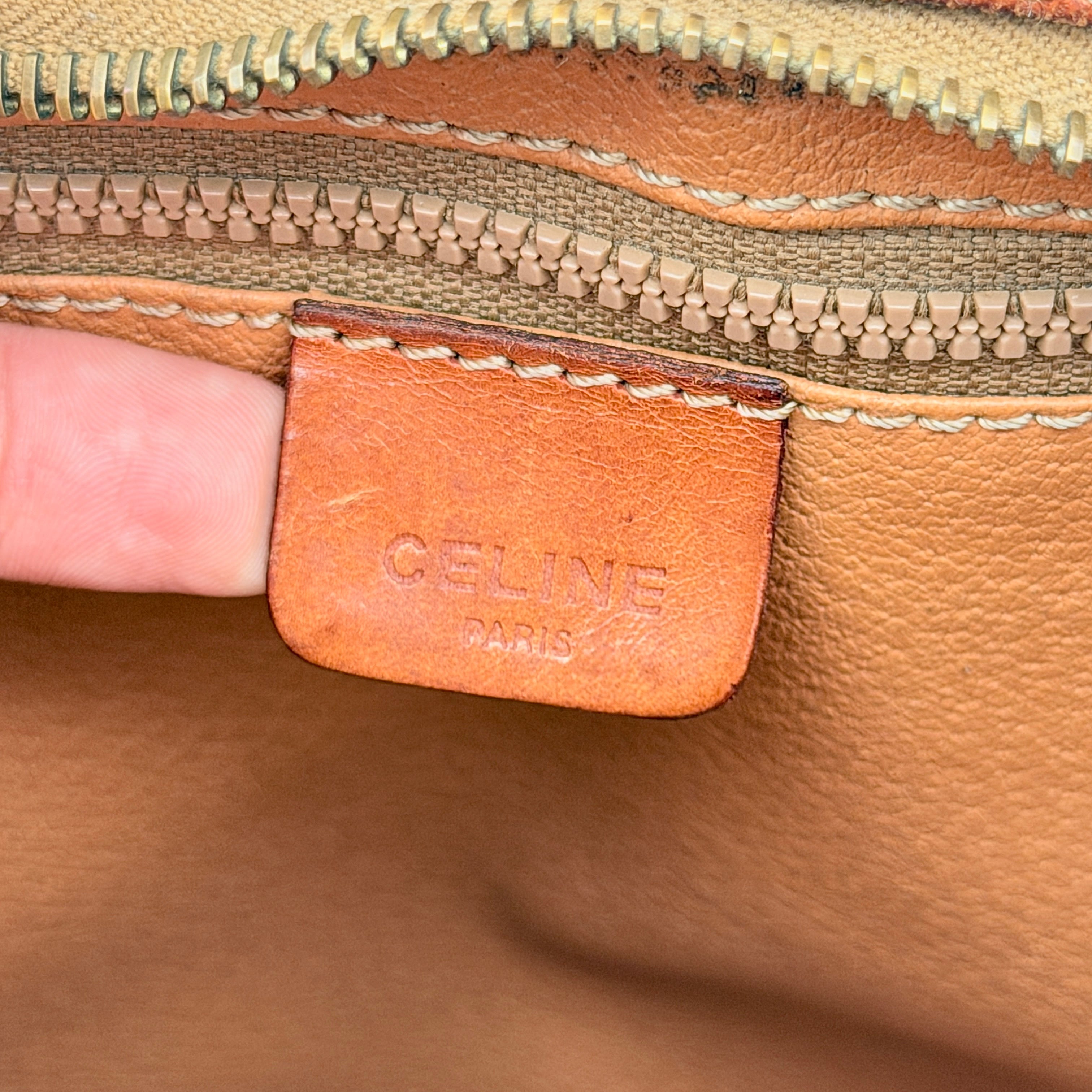 Front view of the Celine Triomphe Macadam clutch bag in brown canvas with tan leather trim and zip pocket.