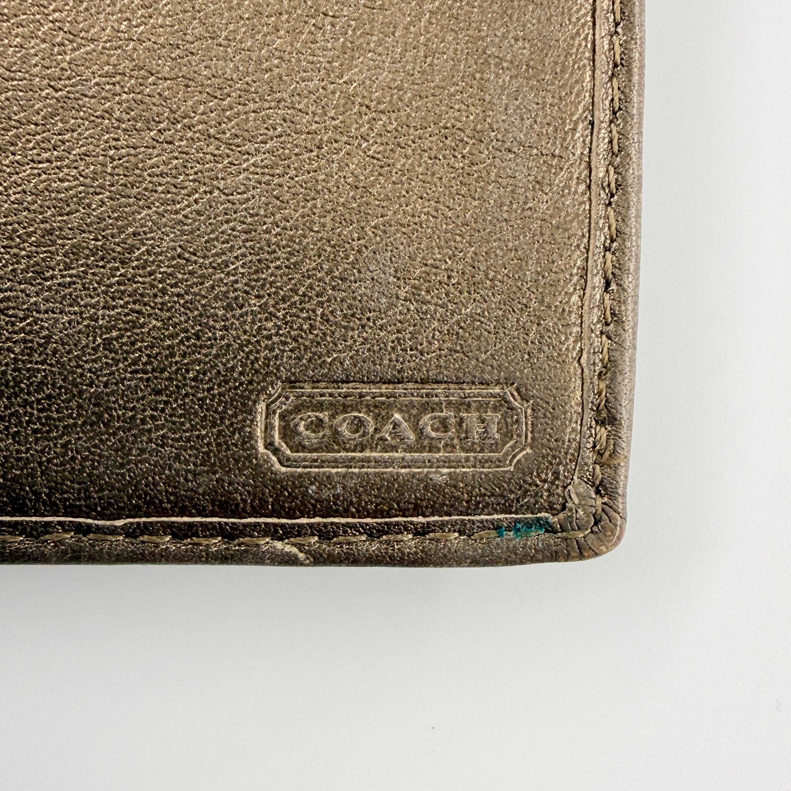 Coach Signature Stripe Snap Wallet in brown jacquard canvas with leather trim and embossed logo, shown against a white background.
