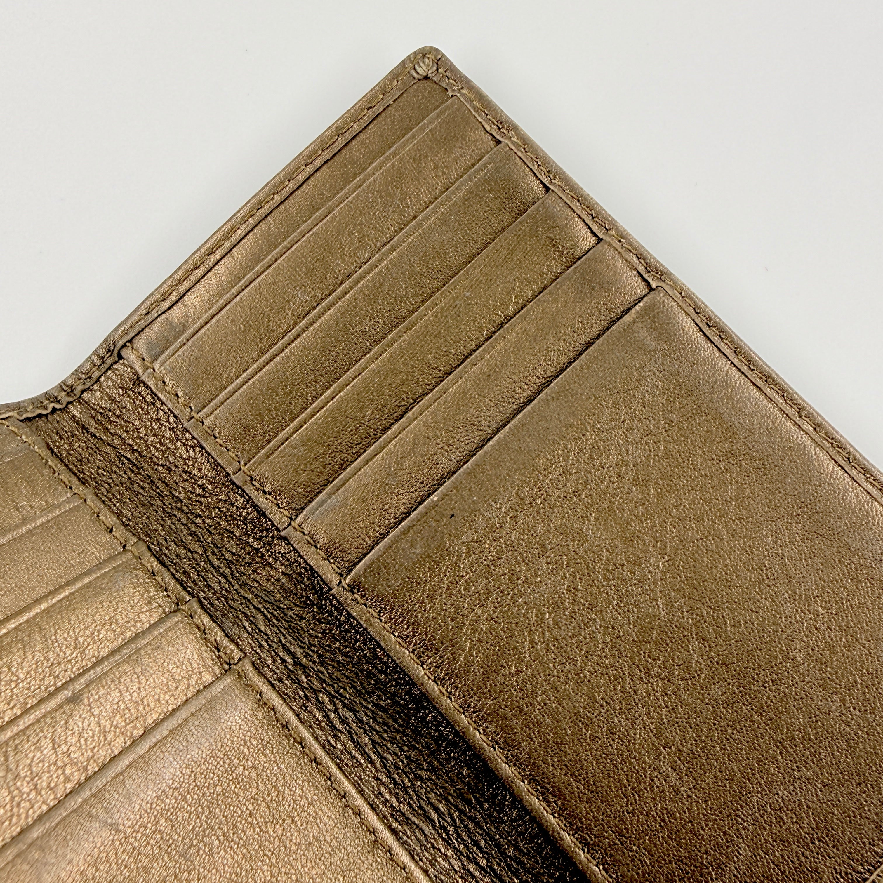 Coach Signature Stripe Snap Wallet in brown jacquard canvas with leather trim and embossed logo, shown against a white background.