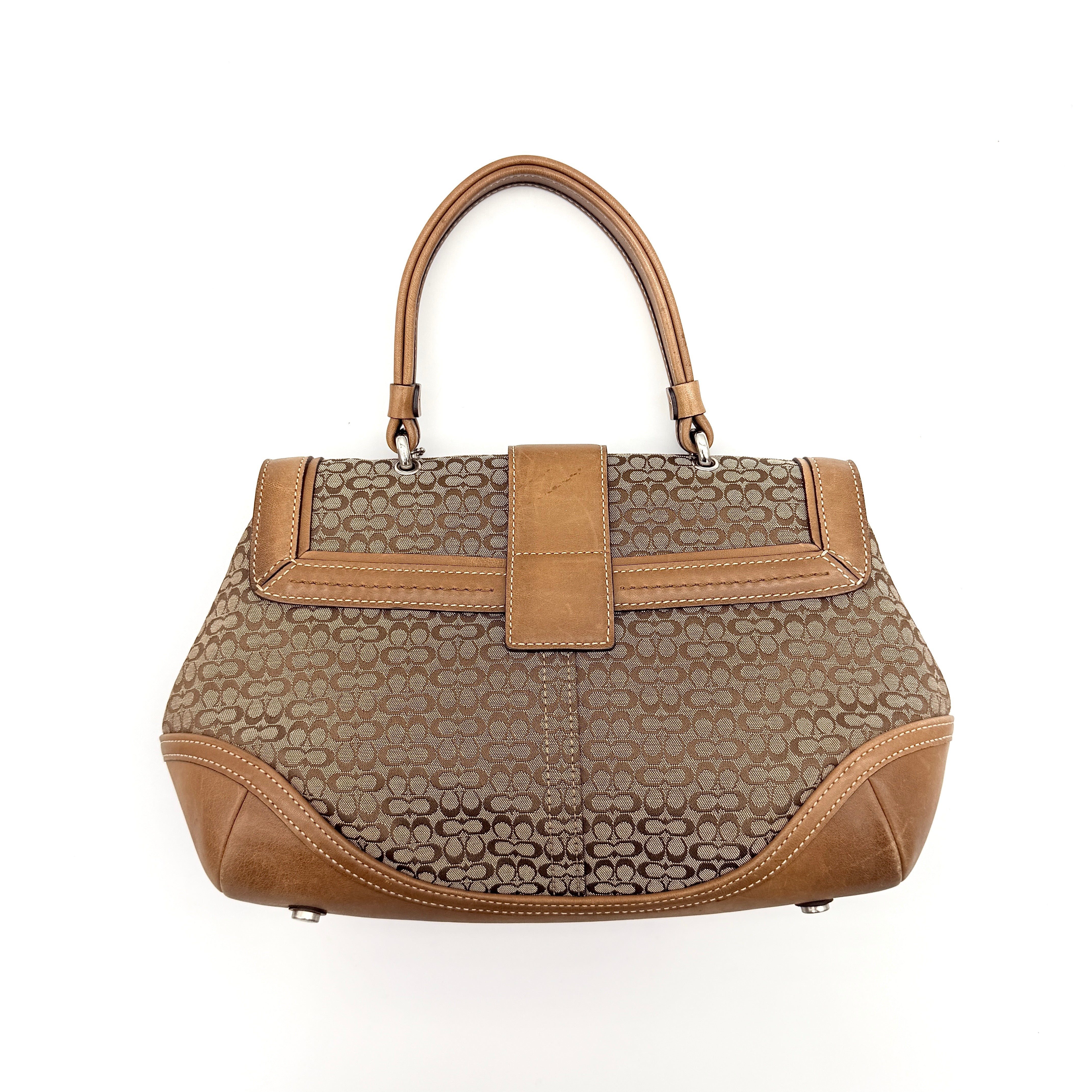 Coach Signature Soho shoulder bag in beige jacquard canvas with tan leather trim and silver buckle, shown against a white background.