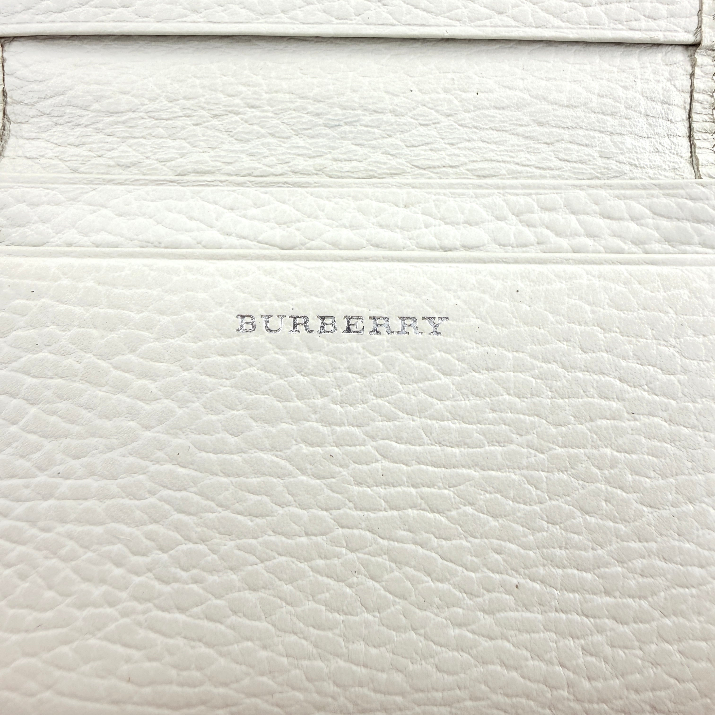 Burberry Nova Check card holder in ivory grained leather with subtle embossed logo, presented closed against a clean background.