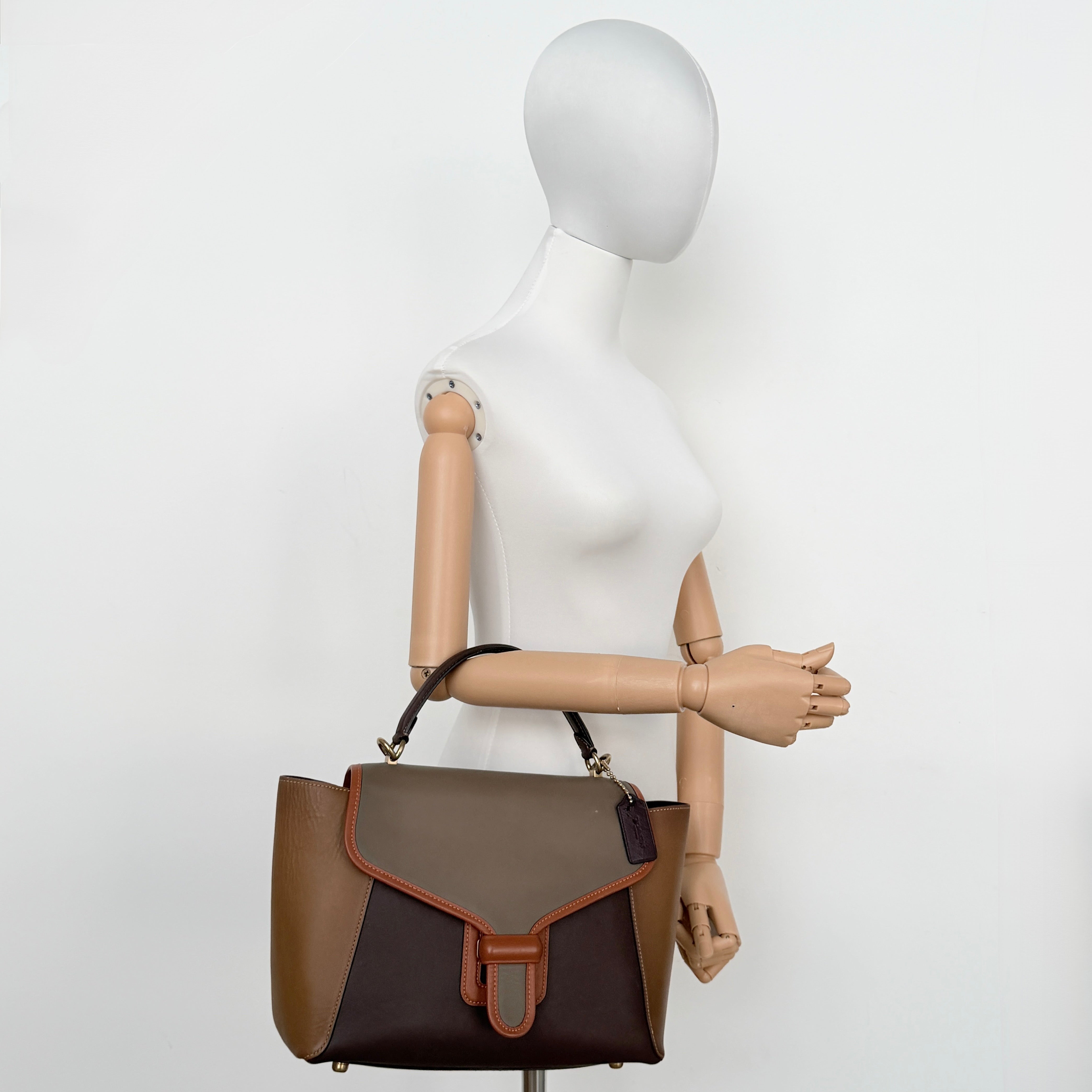 Coach 2Way Courier Carryall in brown and olive green colorblock leather with a structured silhouette, top handle, and detachable strap.