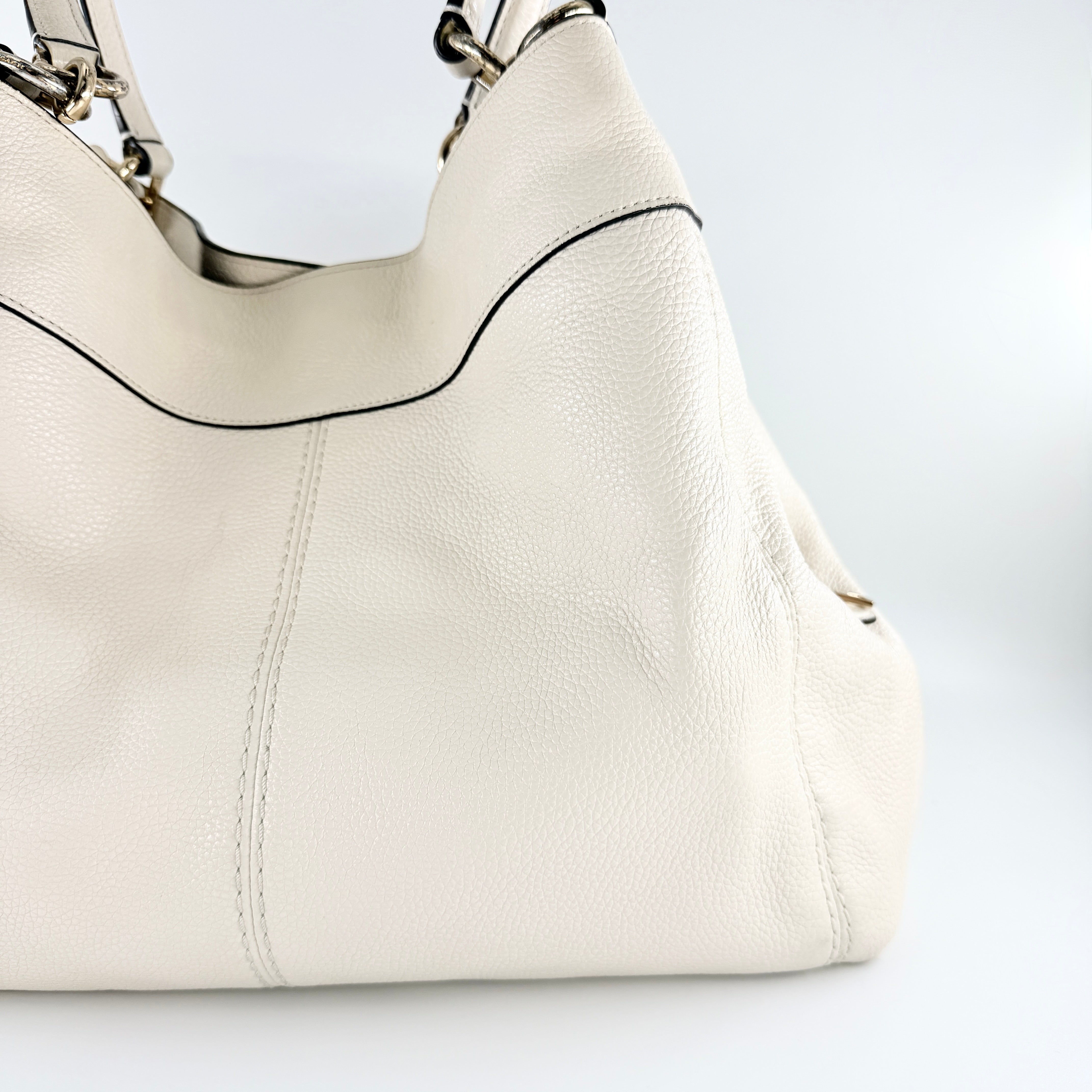 Coach Lexy Stardust Studded Chalk Hobo in ivory pebbled leather, adorned with mixed metal studs and dual handles.