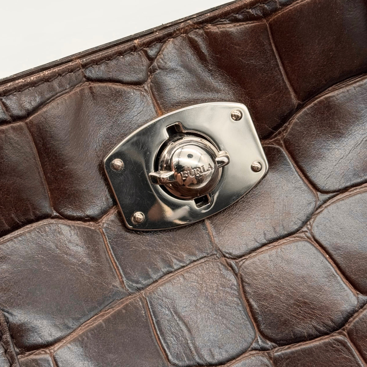 Furla dark brown croc-embossed leather handbag with silver-tone hardware and double top handles, photographed against a clean white background.