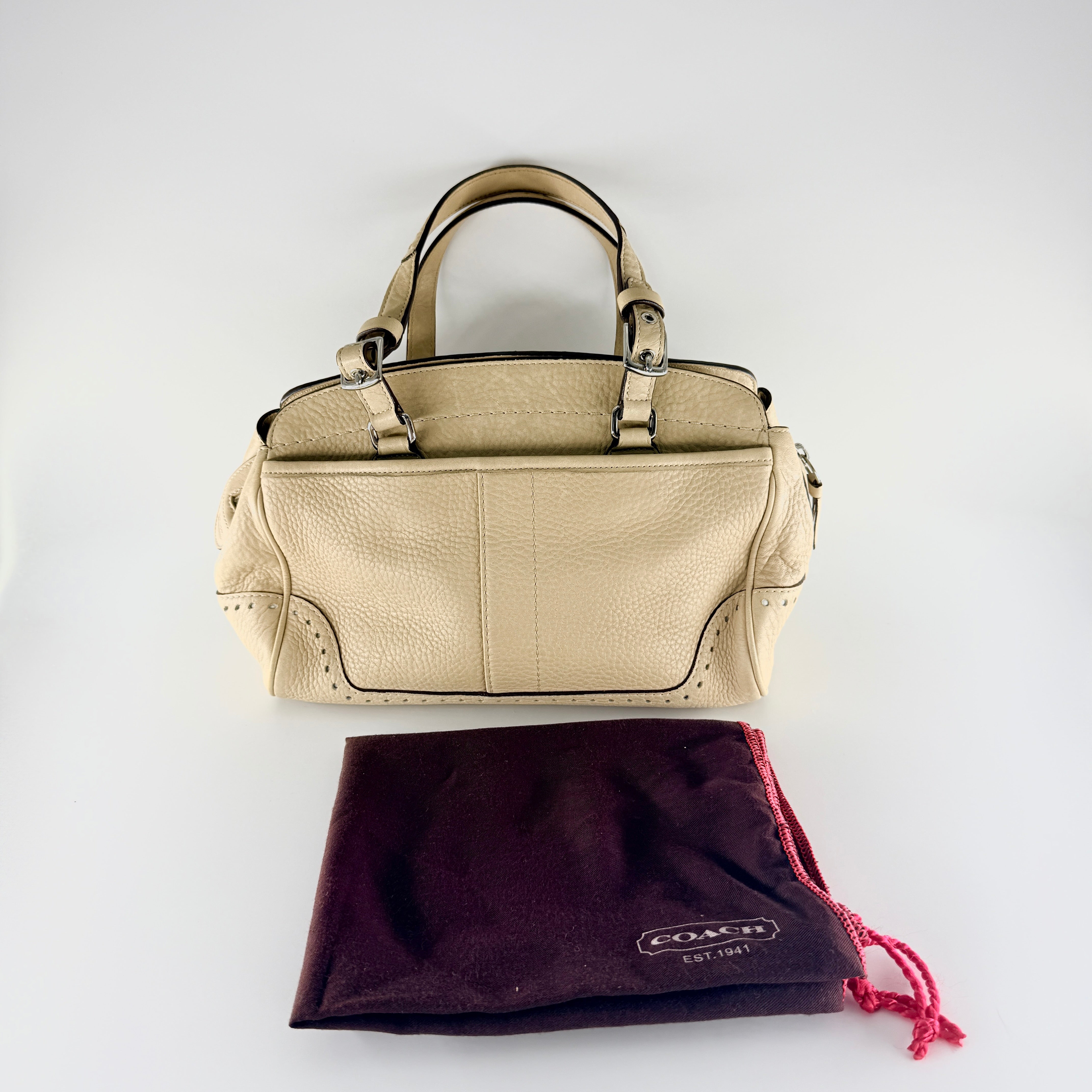 Coach Hampton Sand Satchel in beige pebbled leather with structured dual handles, front zip pocket, and silver-tone hardware.