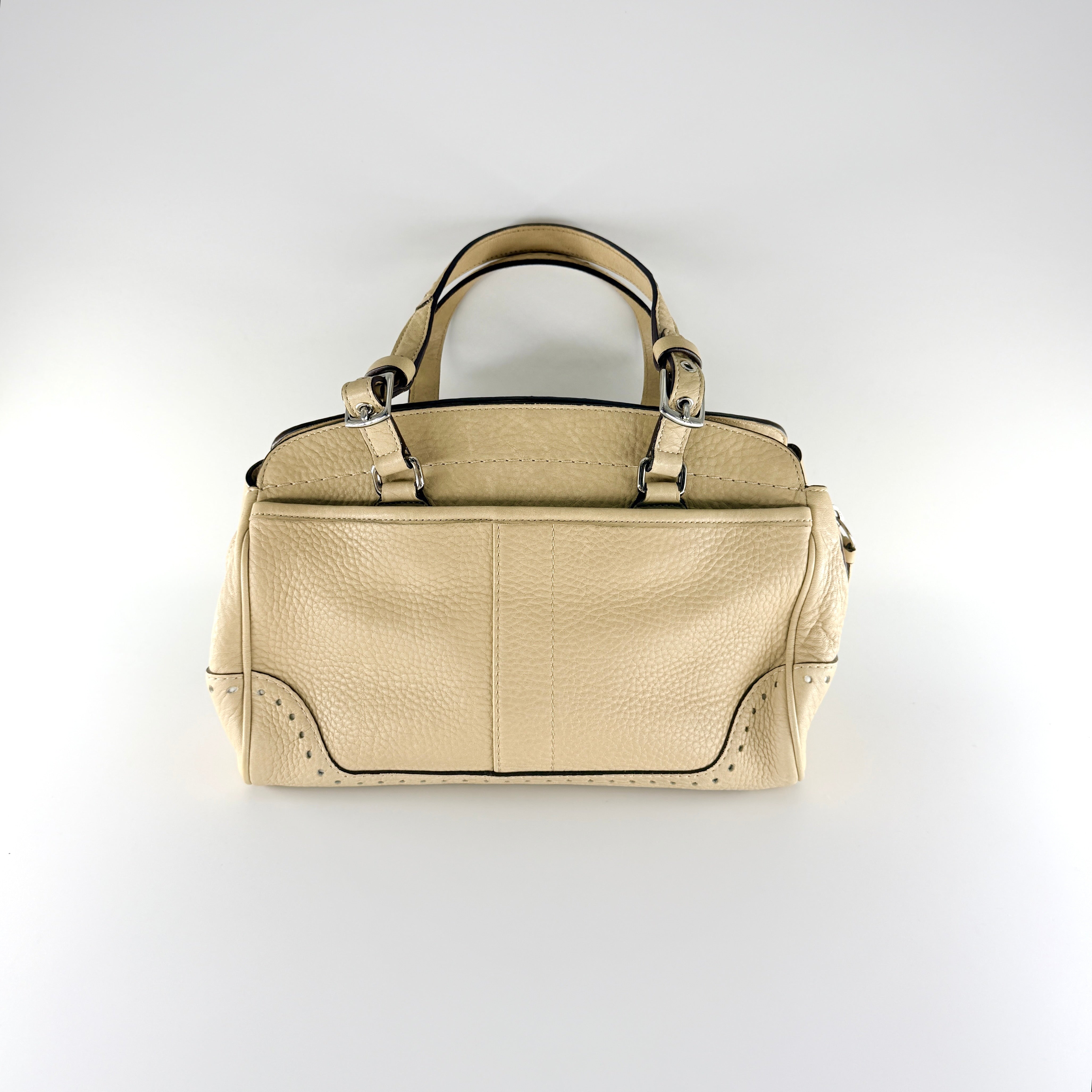 Coach Hampton Sand Satchel in beige pebbled leather with structured dual handles, front zip pocket, and silver-tone hardware.