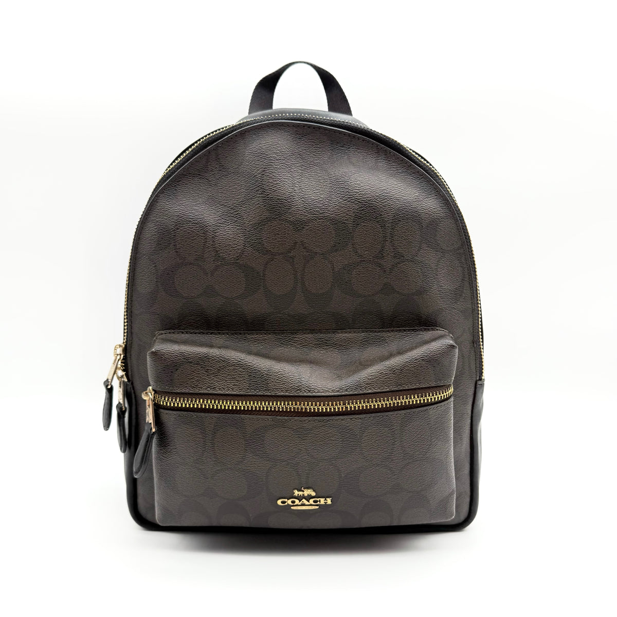 Coach Signature Charlie Backpack in brown and black canvas with gold-tone hardware and front zip pocket.