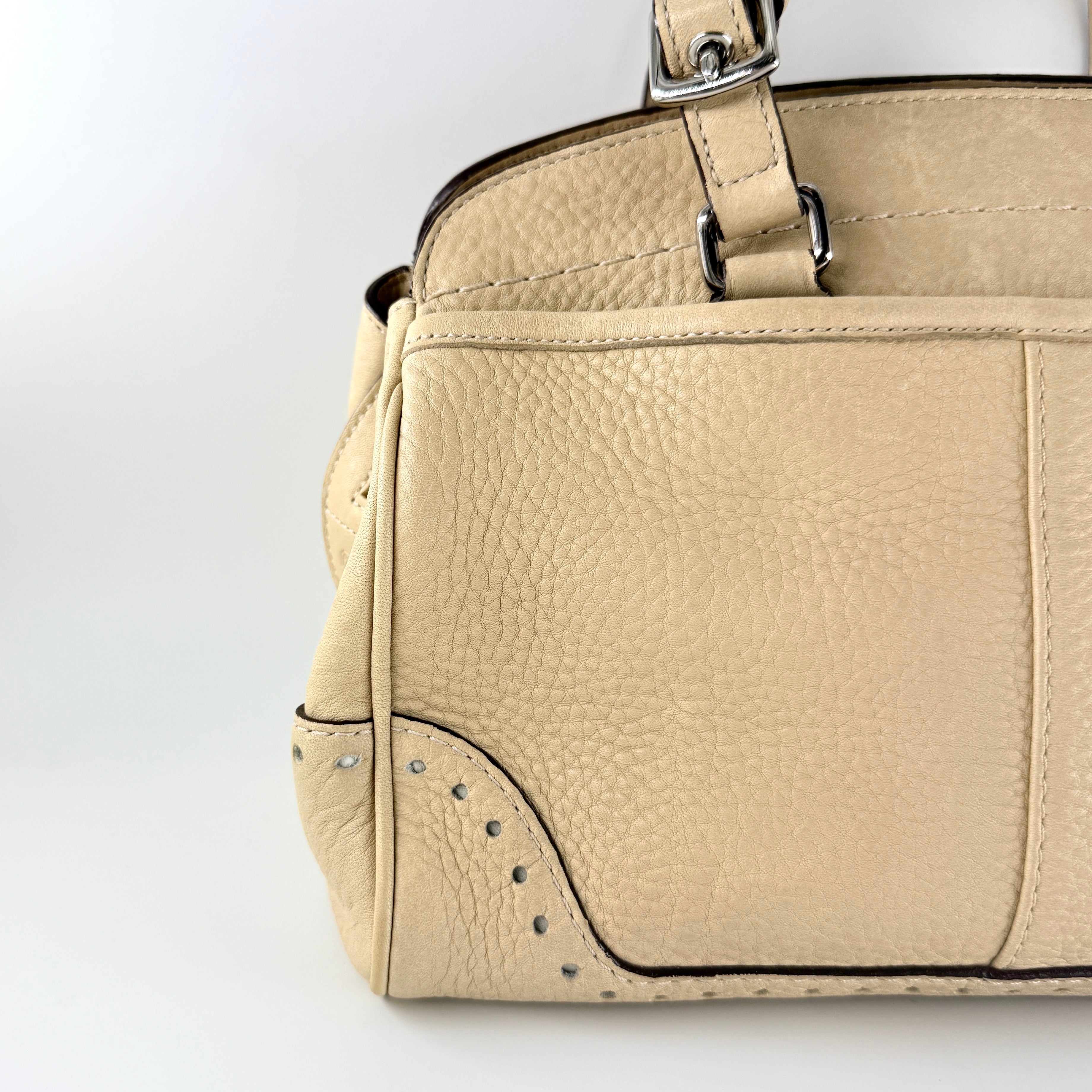 Coach Hampton Sand Satchel in beige pebbled leather with structured dual handles, front zip pocket, and silver-tone hardware.