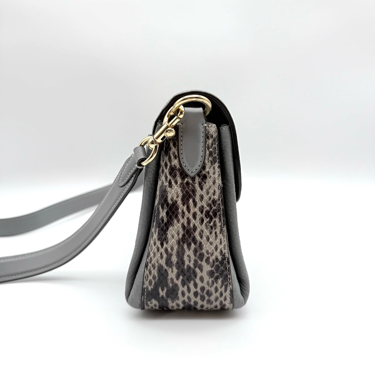 Coach Grace grey pebbled leather shoulder bag with python-embossed sides and gold coach carriage hardware, styled with a long adjustable strap.