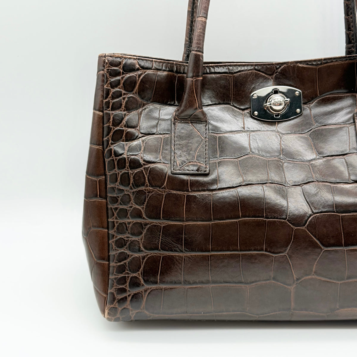 Furla dark brown croc-embossed leather handbag with silver-tone hardware and double top handles, photographed against a clean white background.