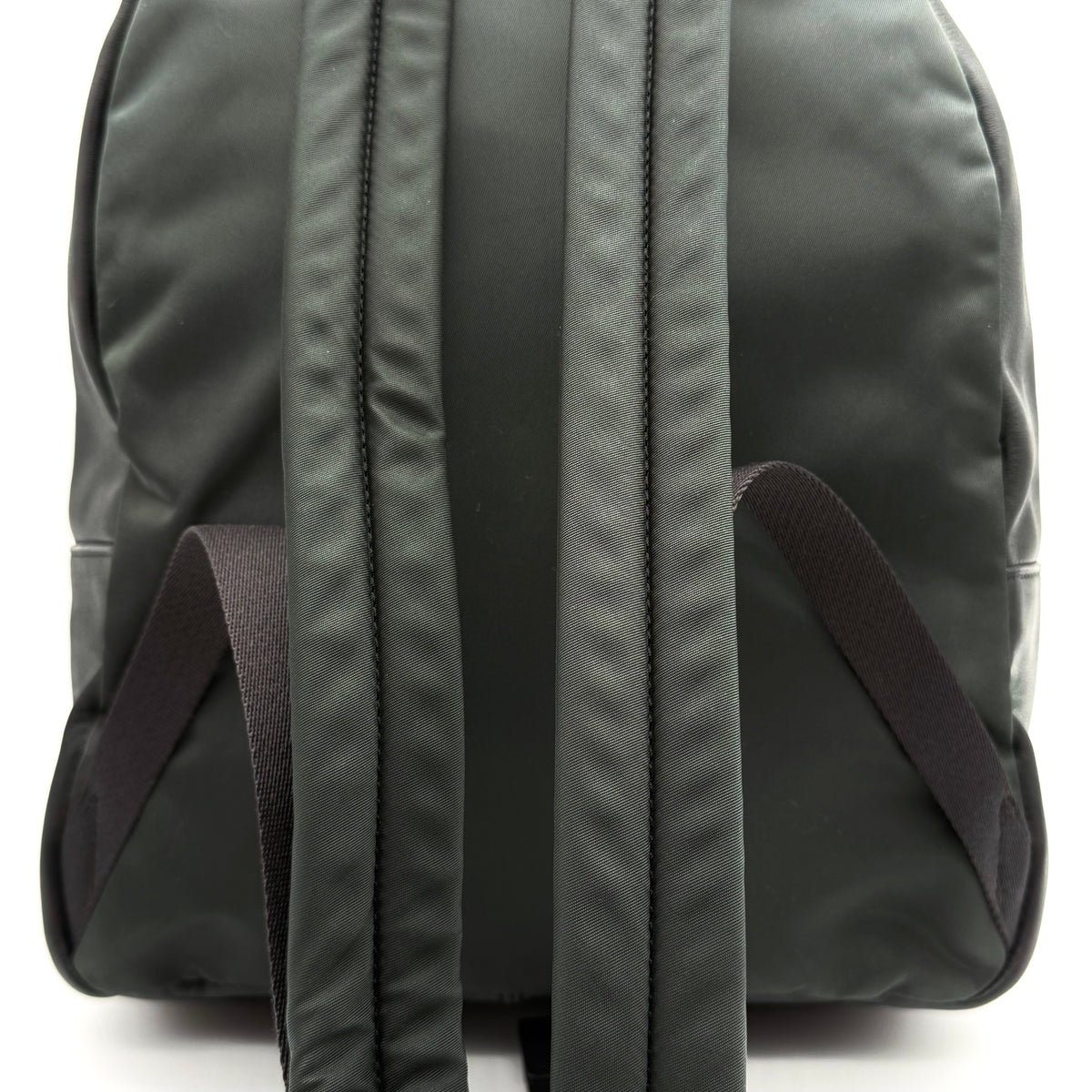 Coach Signature Charlie Backpack in brown and black canvas with gold-tone hardware and front zip pocket.