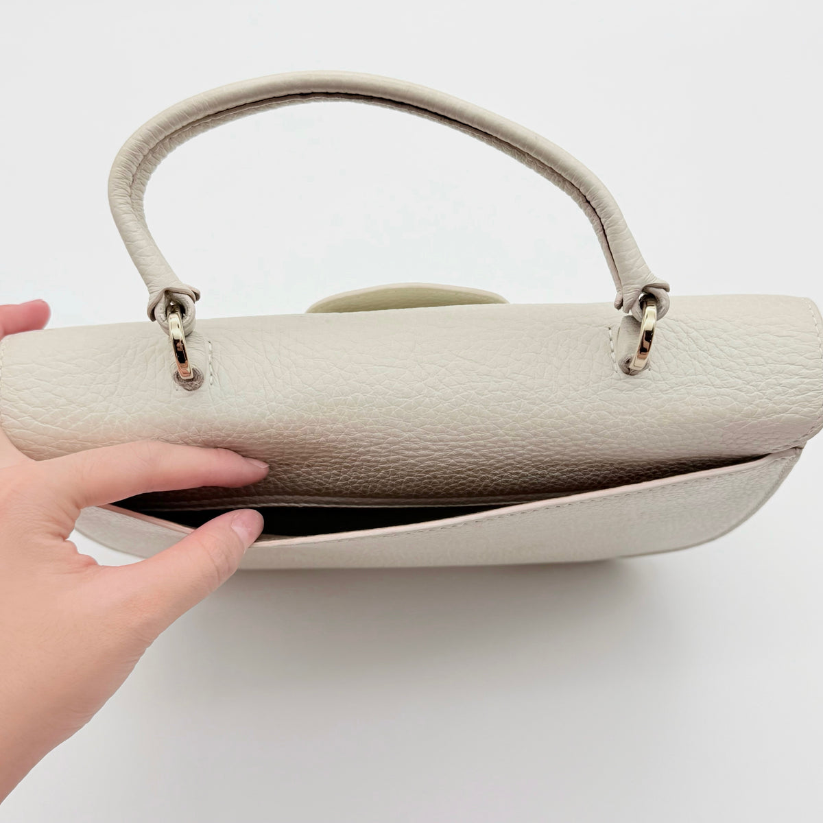 Furla 2Way Ducale Mini Handbag in creamy white leather with gold hardware, top handle, and detachable strap displayed flat with authenticity card.